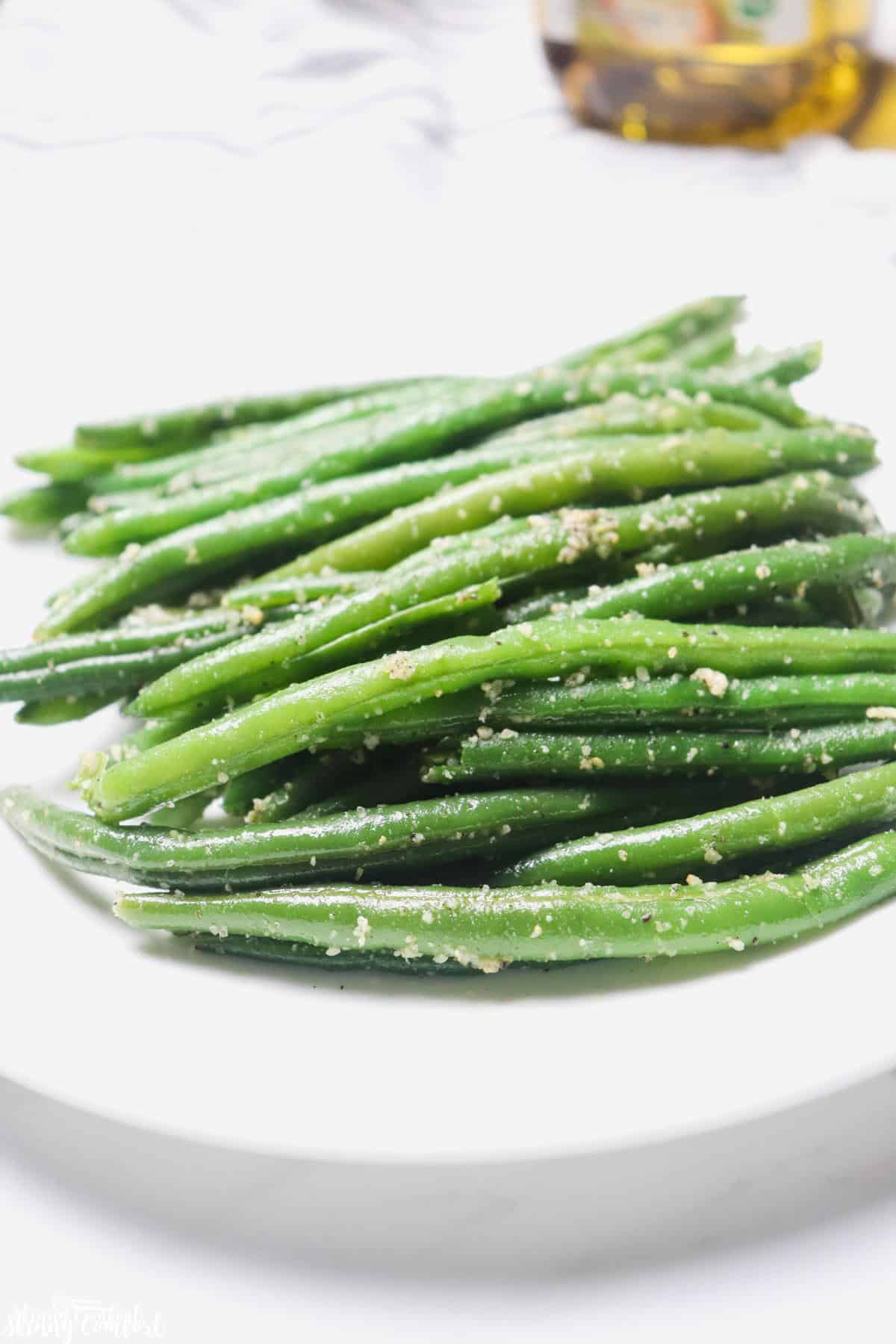 Cooked garlic Parmesan green beans on plate