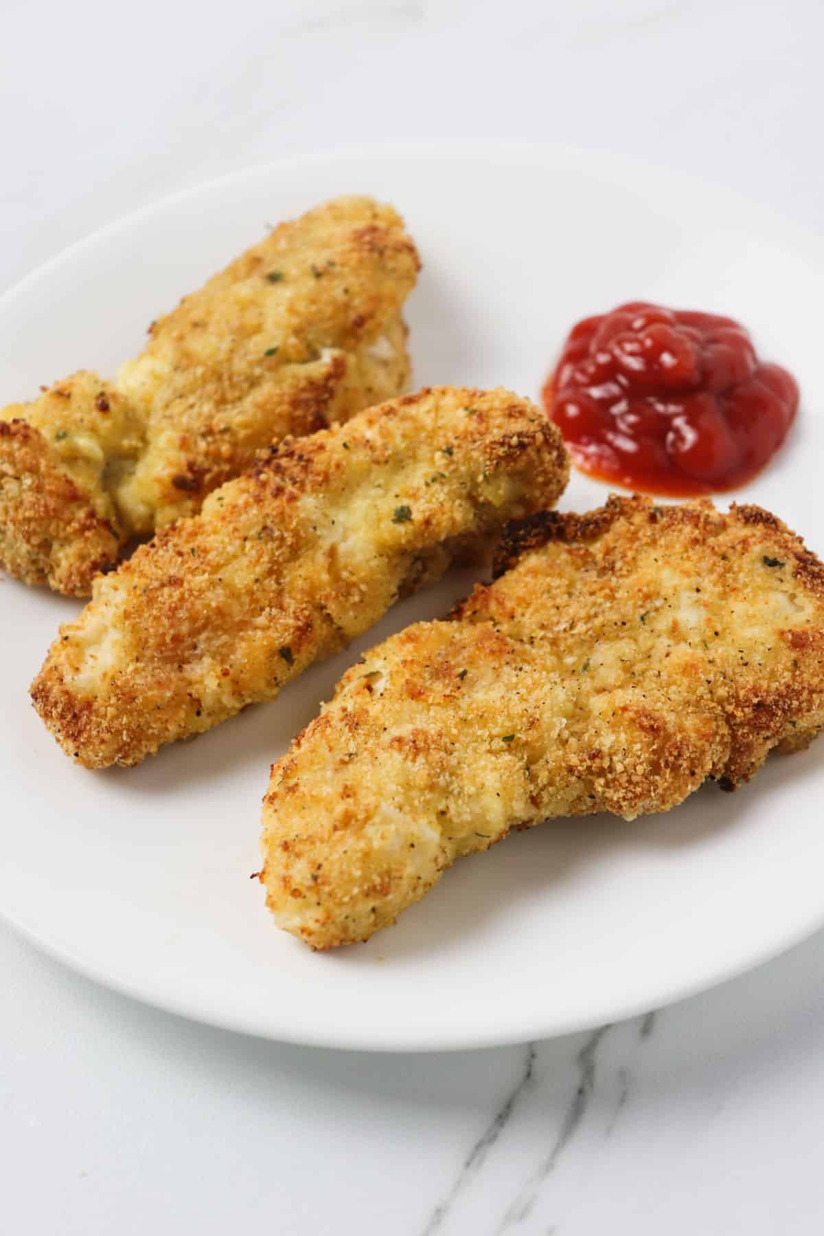 air fried chicken tenders with ketchup on plate