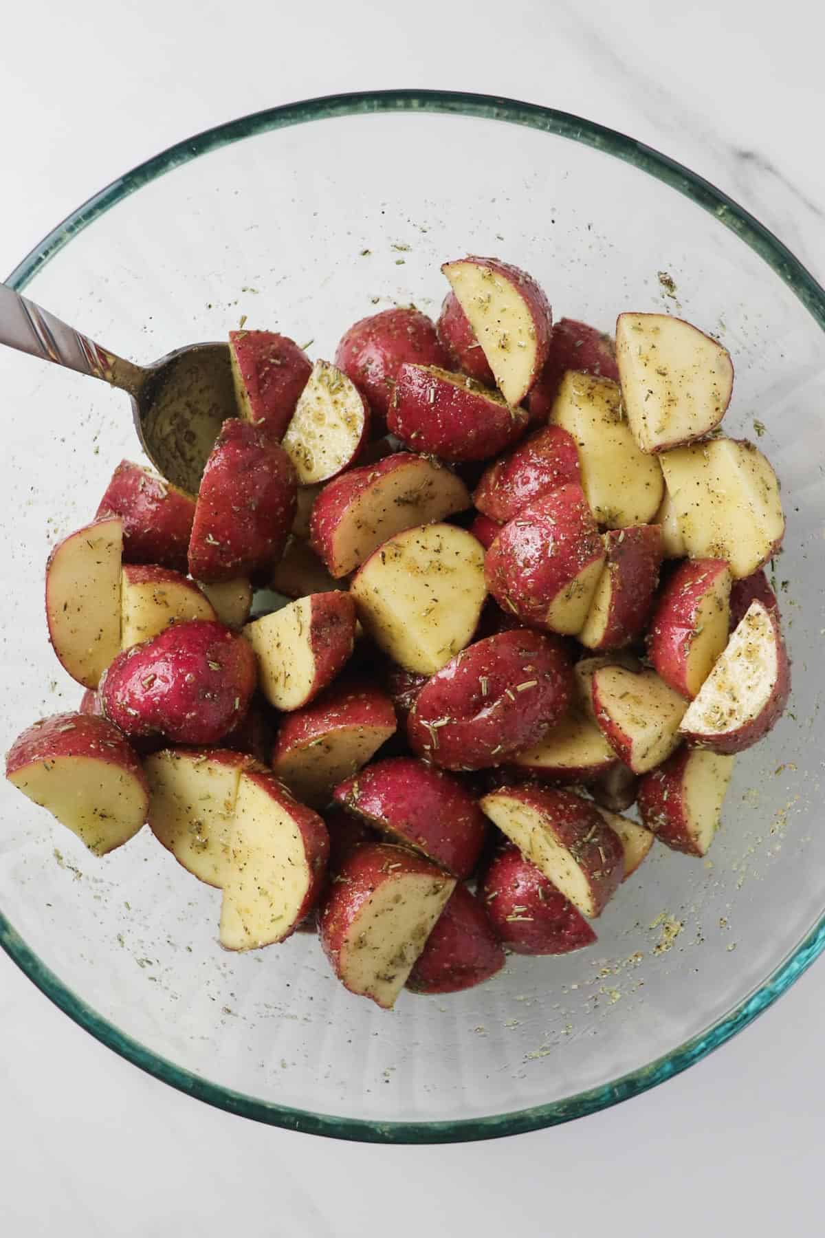diced red potatoes in bowl with seasoning
