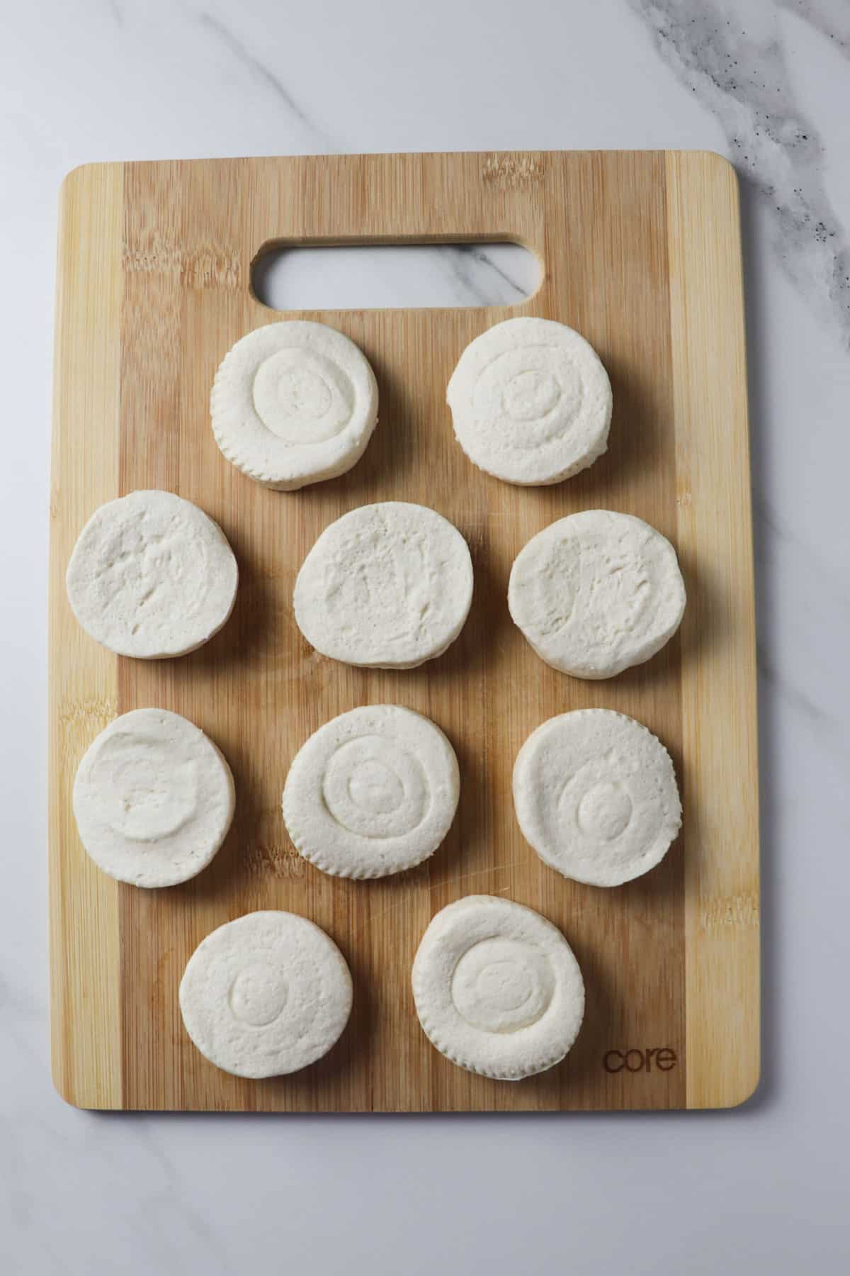 biscuits laid out on wooden cutting board