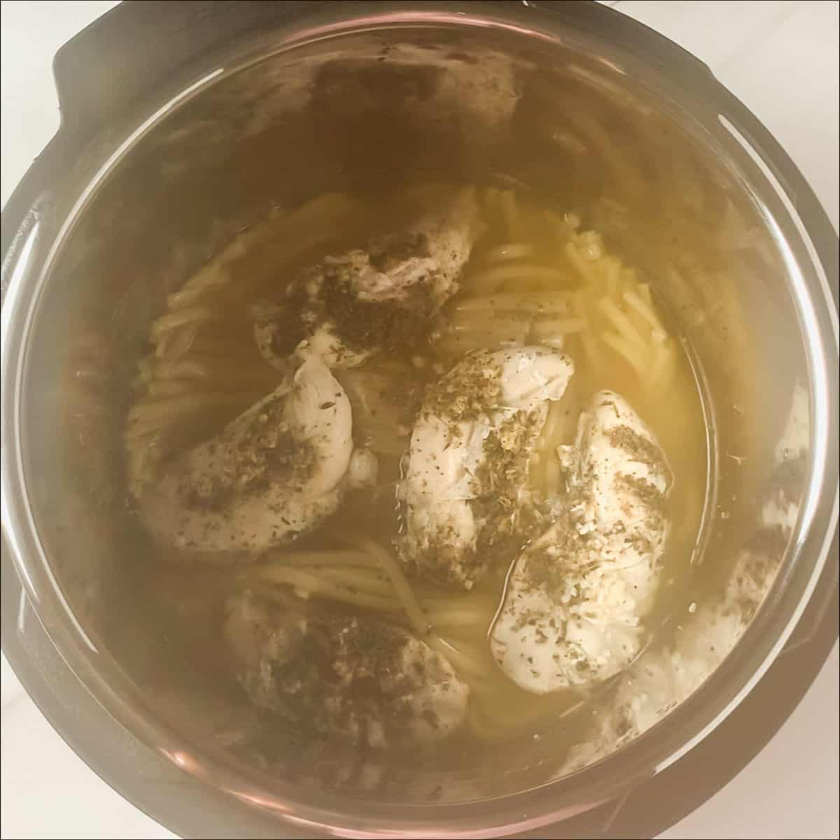 cooked chicken tenders on top of pasta in instant pot