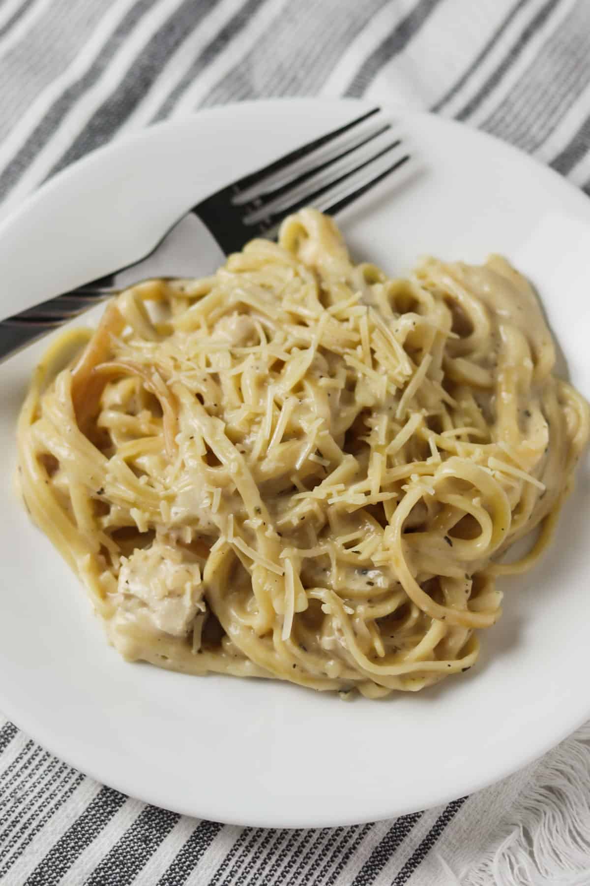 chicken alfredo on plate with fork