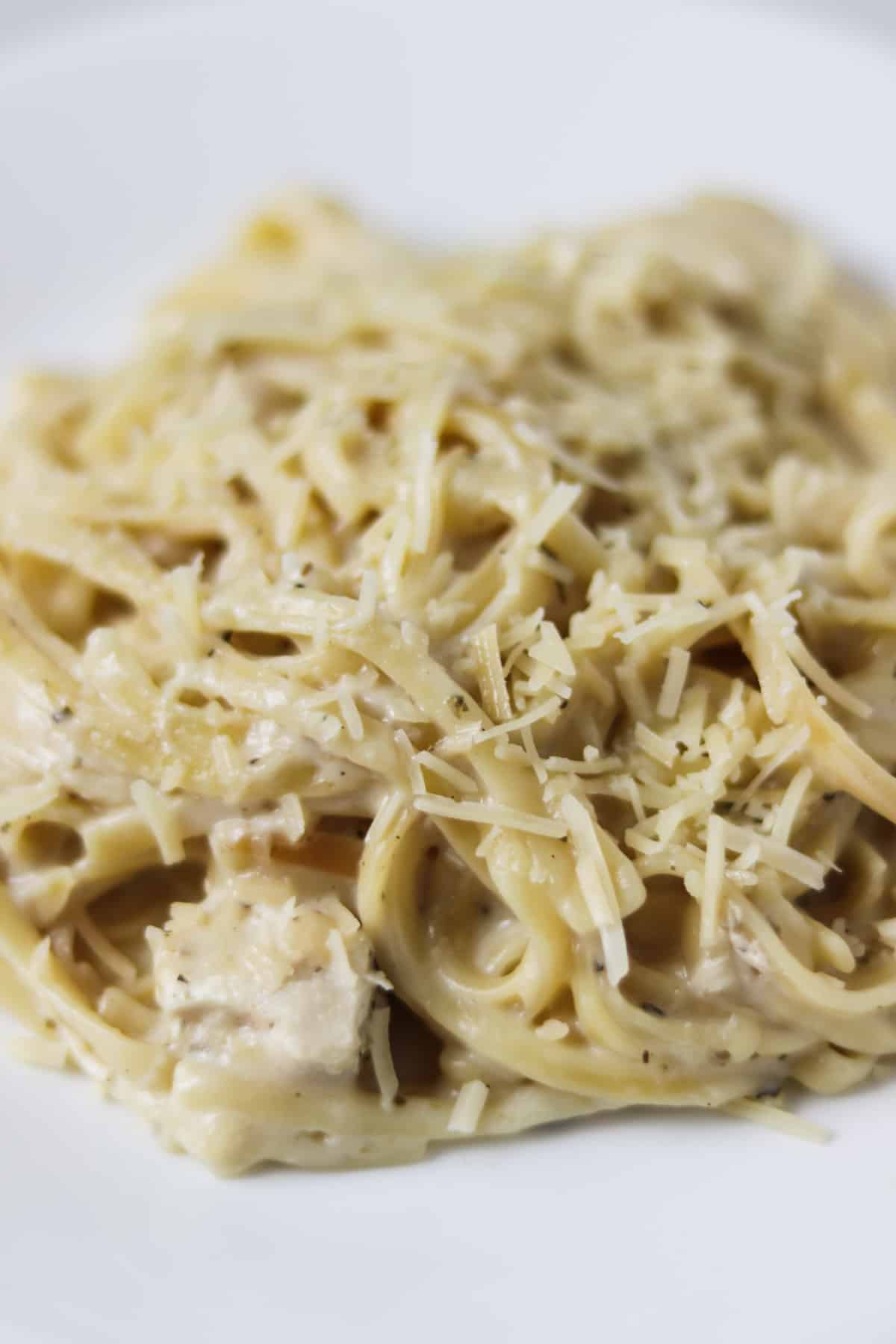 instant pot chicken alfredo on plate with parmesan cheese on top