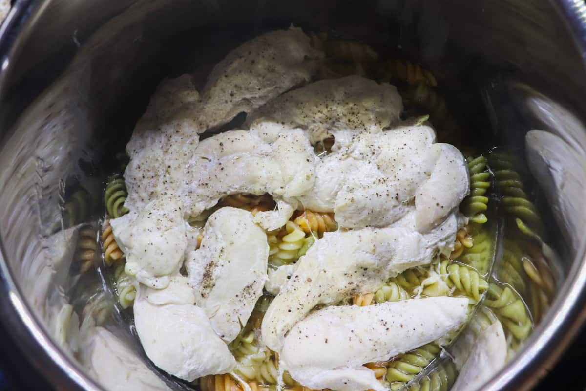cooked chicken tenders and rotini pasta in the instant pot