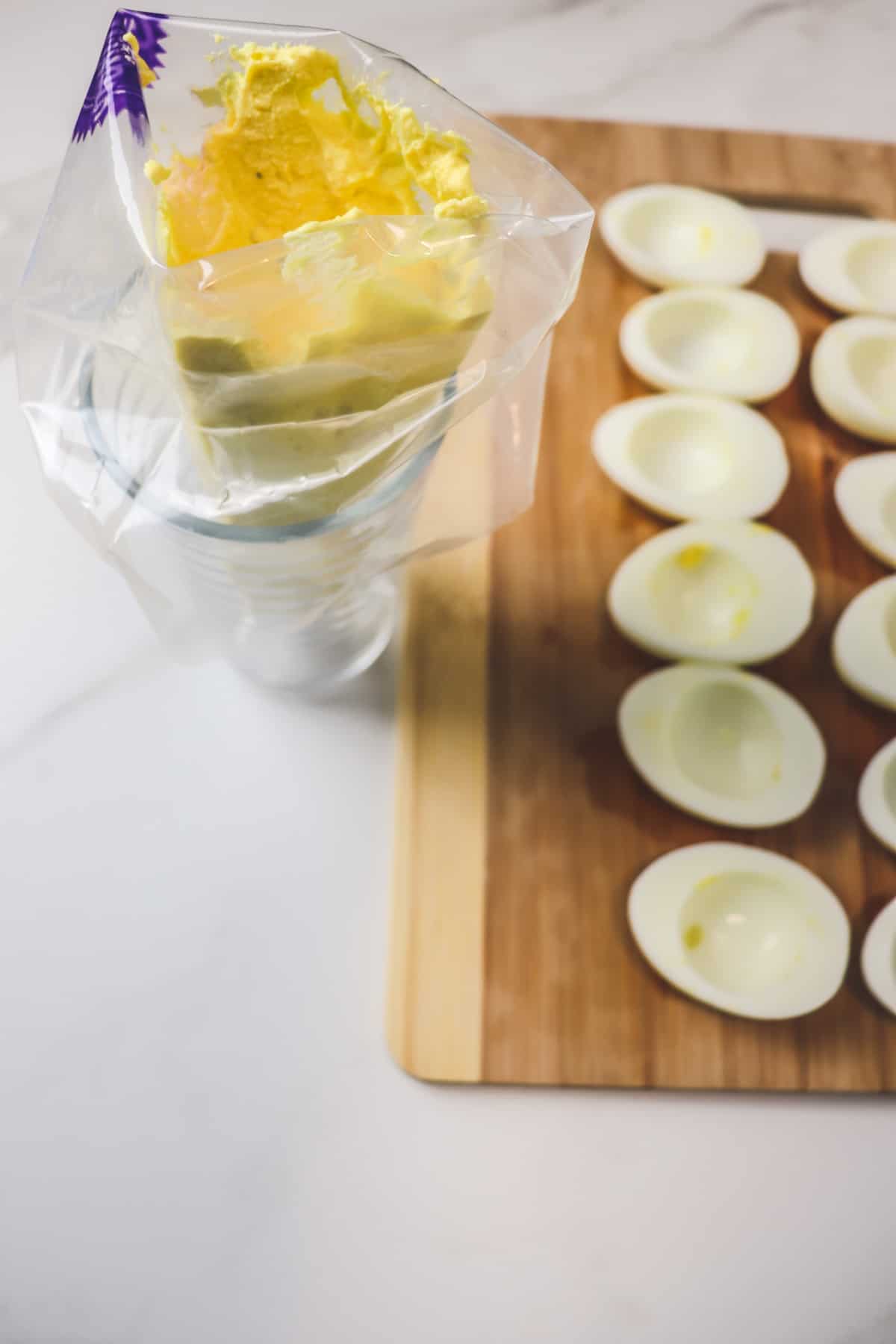 adding deviled egg filling into piping bag