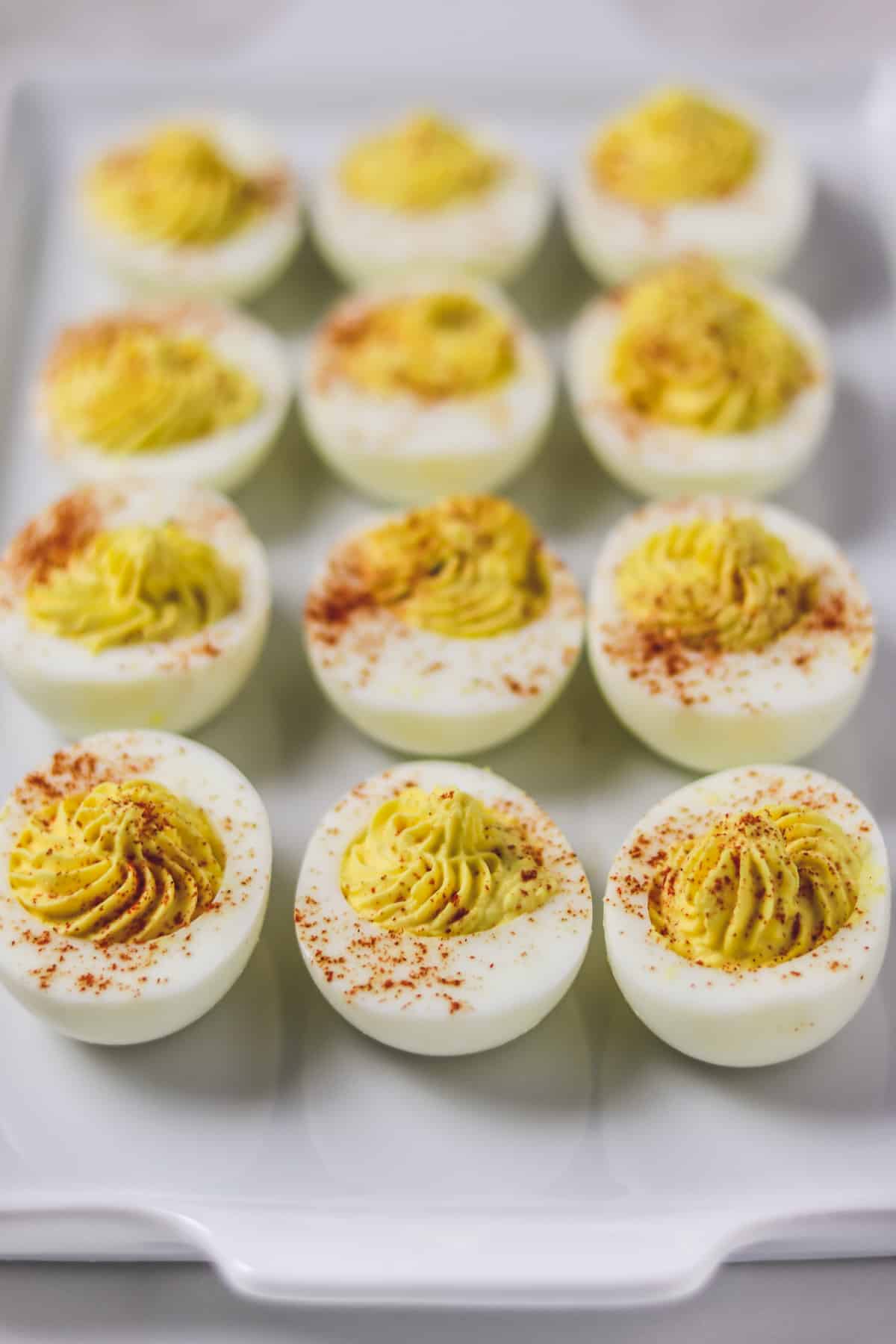 deviled eggs on white serving tray