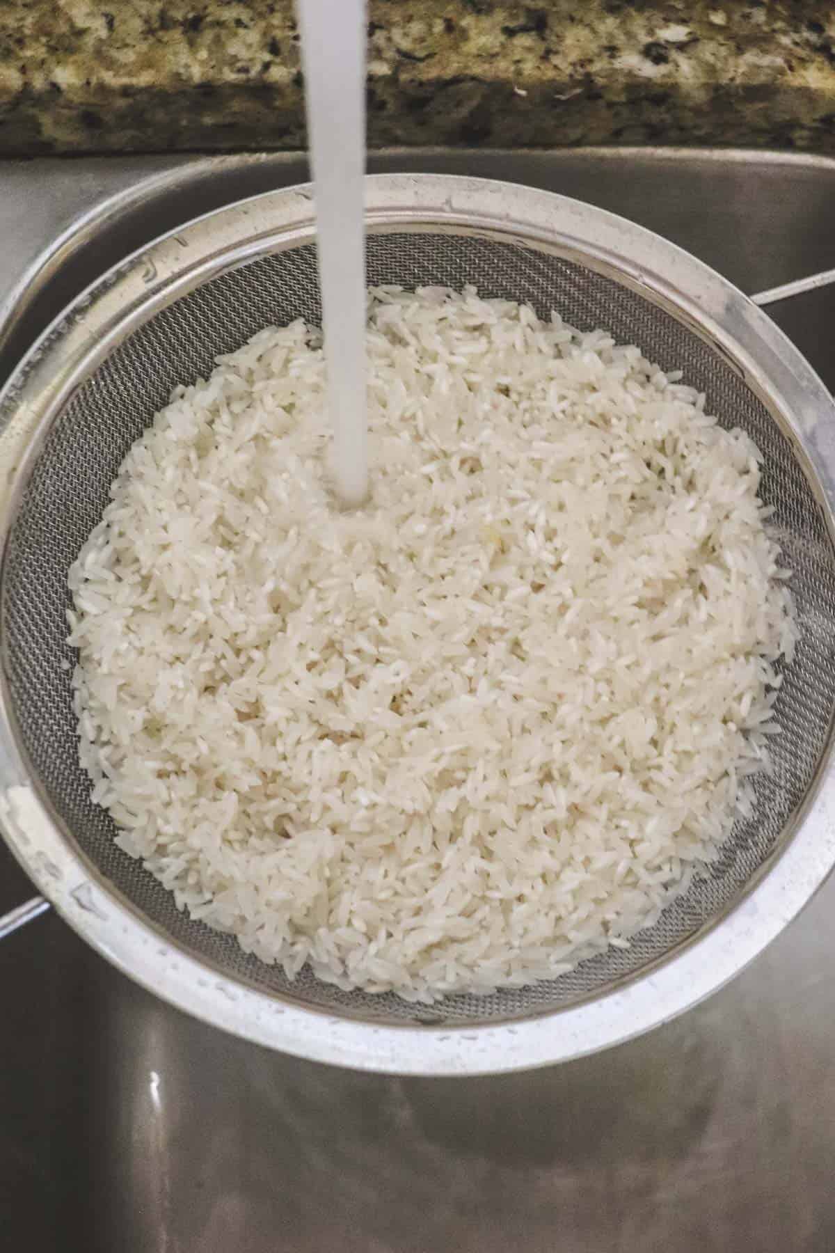 rinsing white rice in the sink