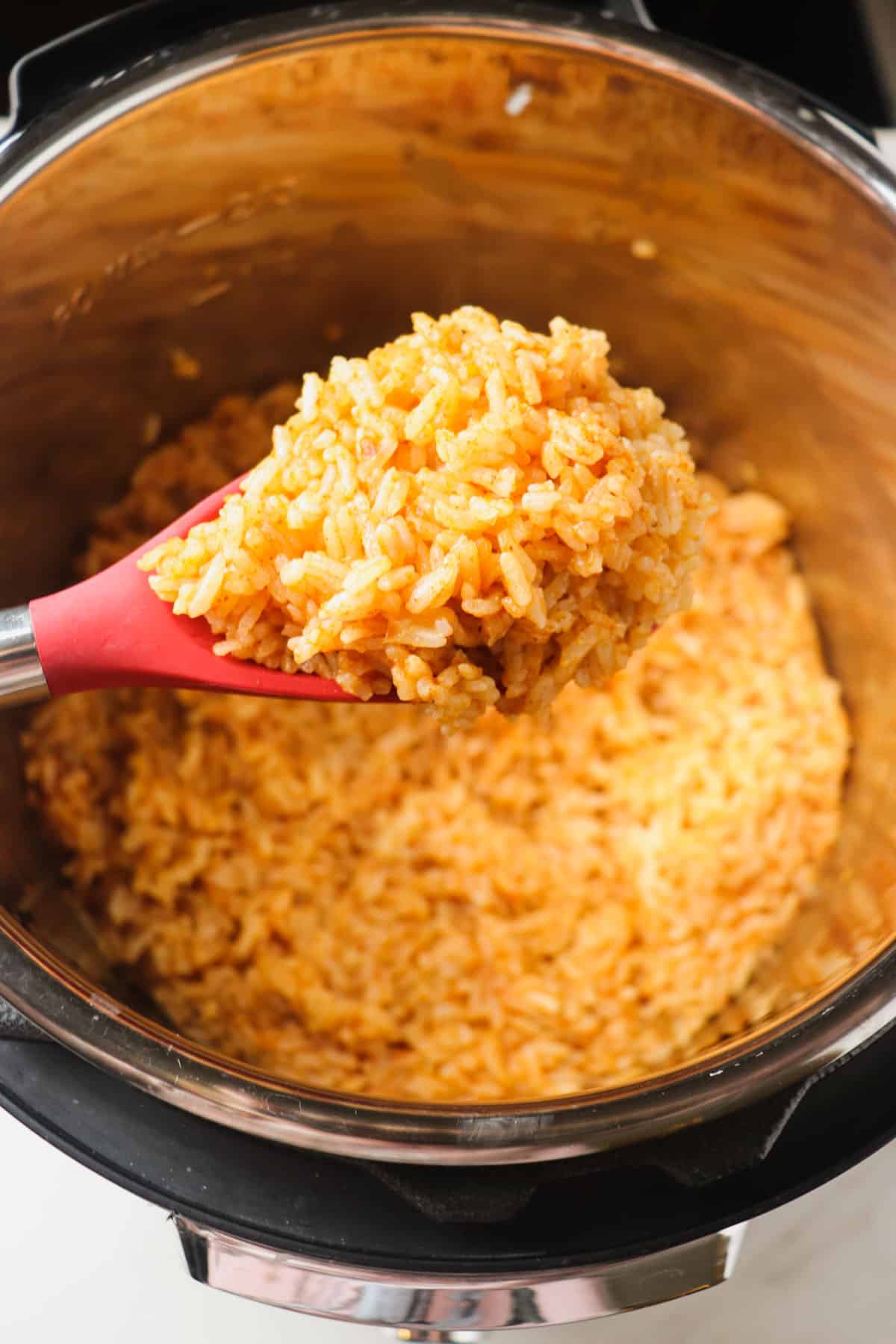 scooping out a spoonful of mexican rice from the instant pot