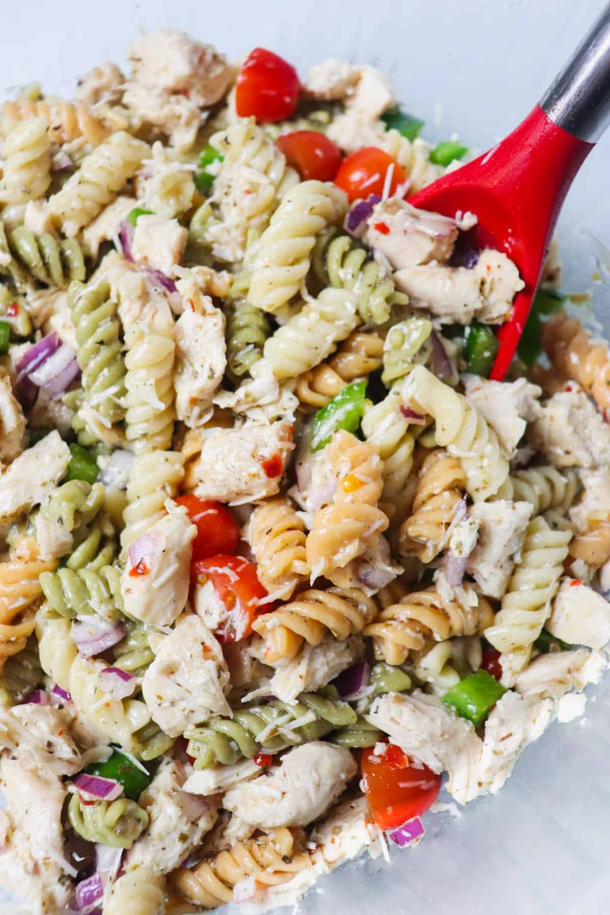 italian chicken pasta salad in bowl with spoon