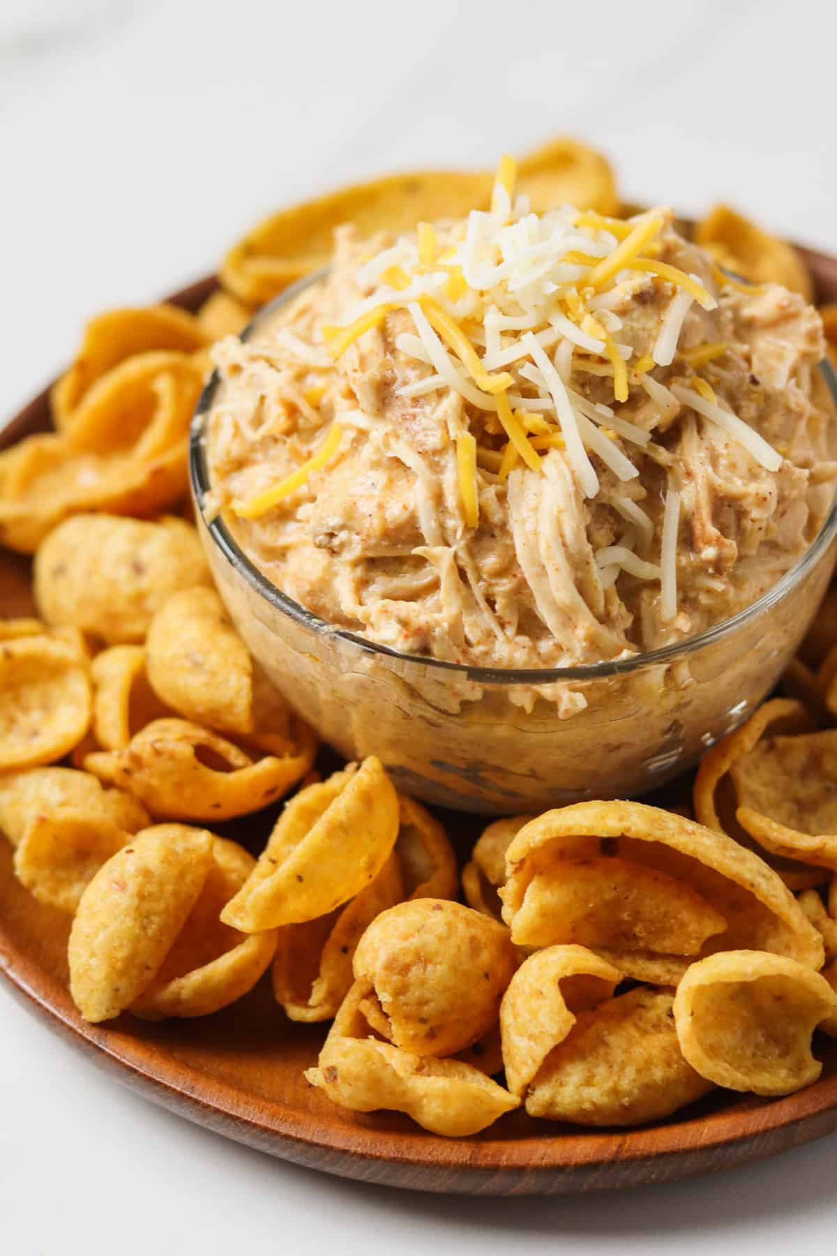 crock pot mexican chicken in glass bowl on plate with corn chips