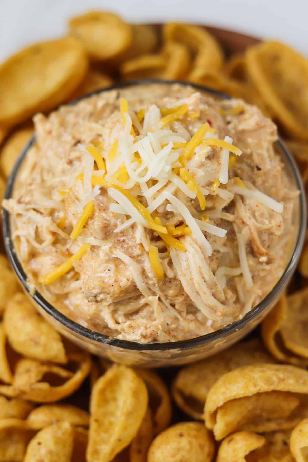 crock pot mexican chicken in glass bowl on plate with corn chips