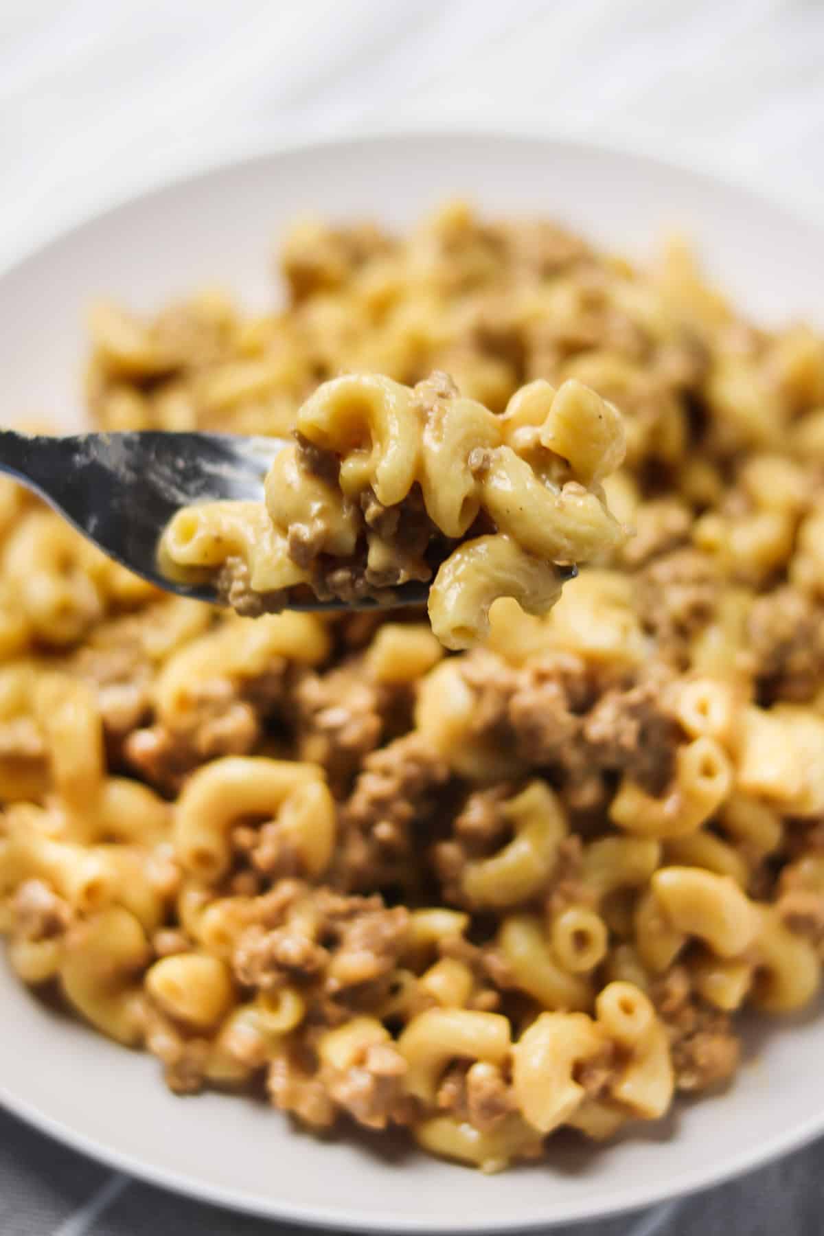 taking a bite of instant pot hamburger helper