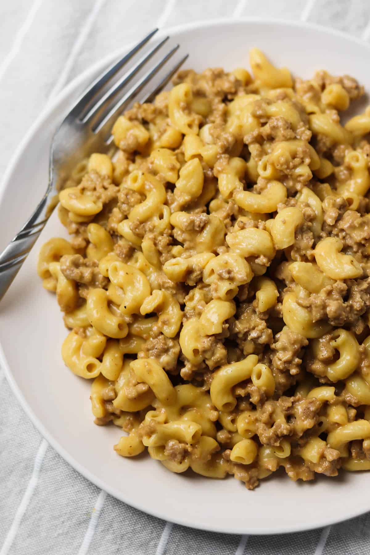 instant pot hamburger helper on white plate with fork