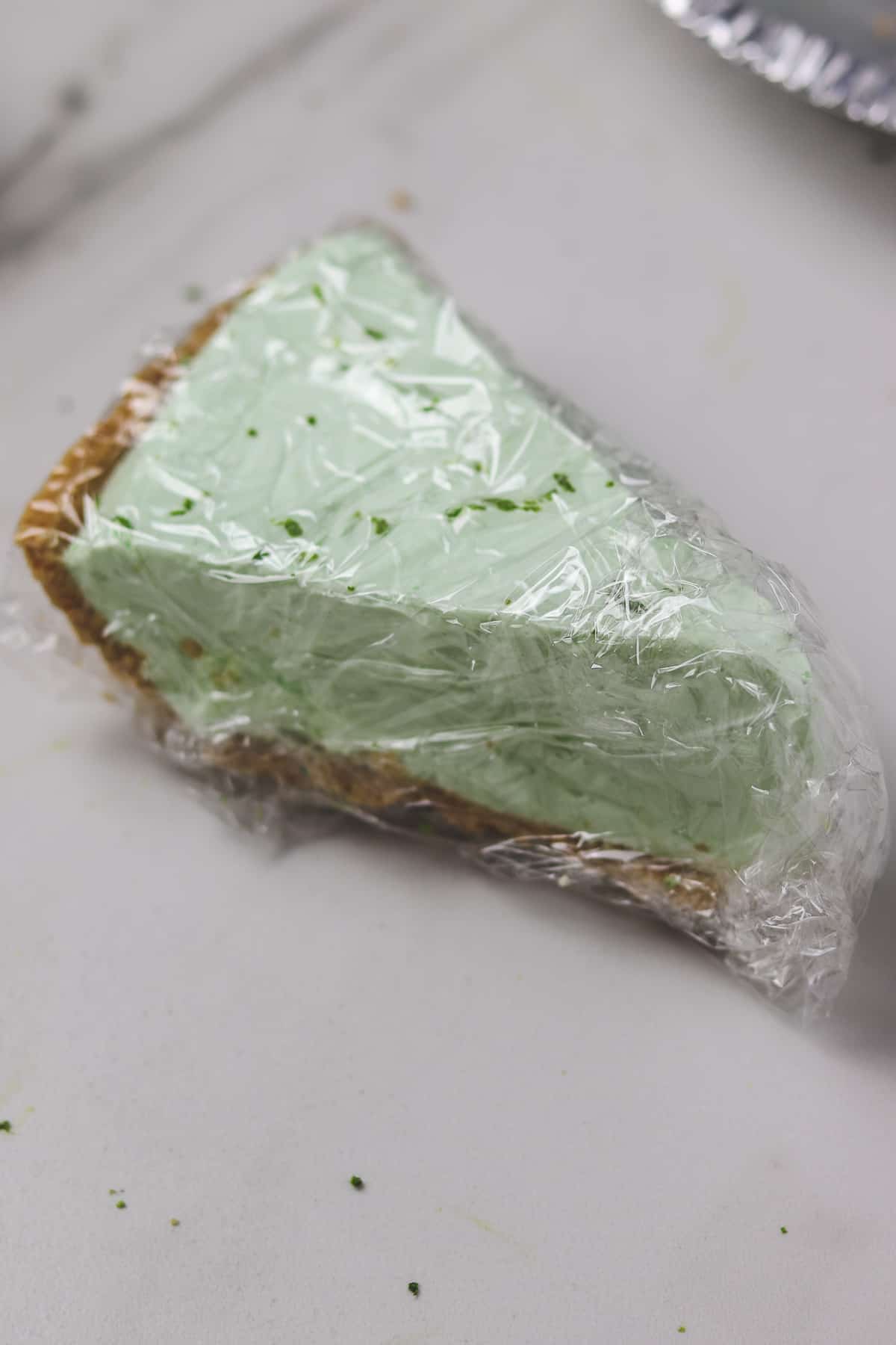 piece of pie wrapped in plastic wrap for freezing