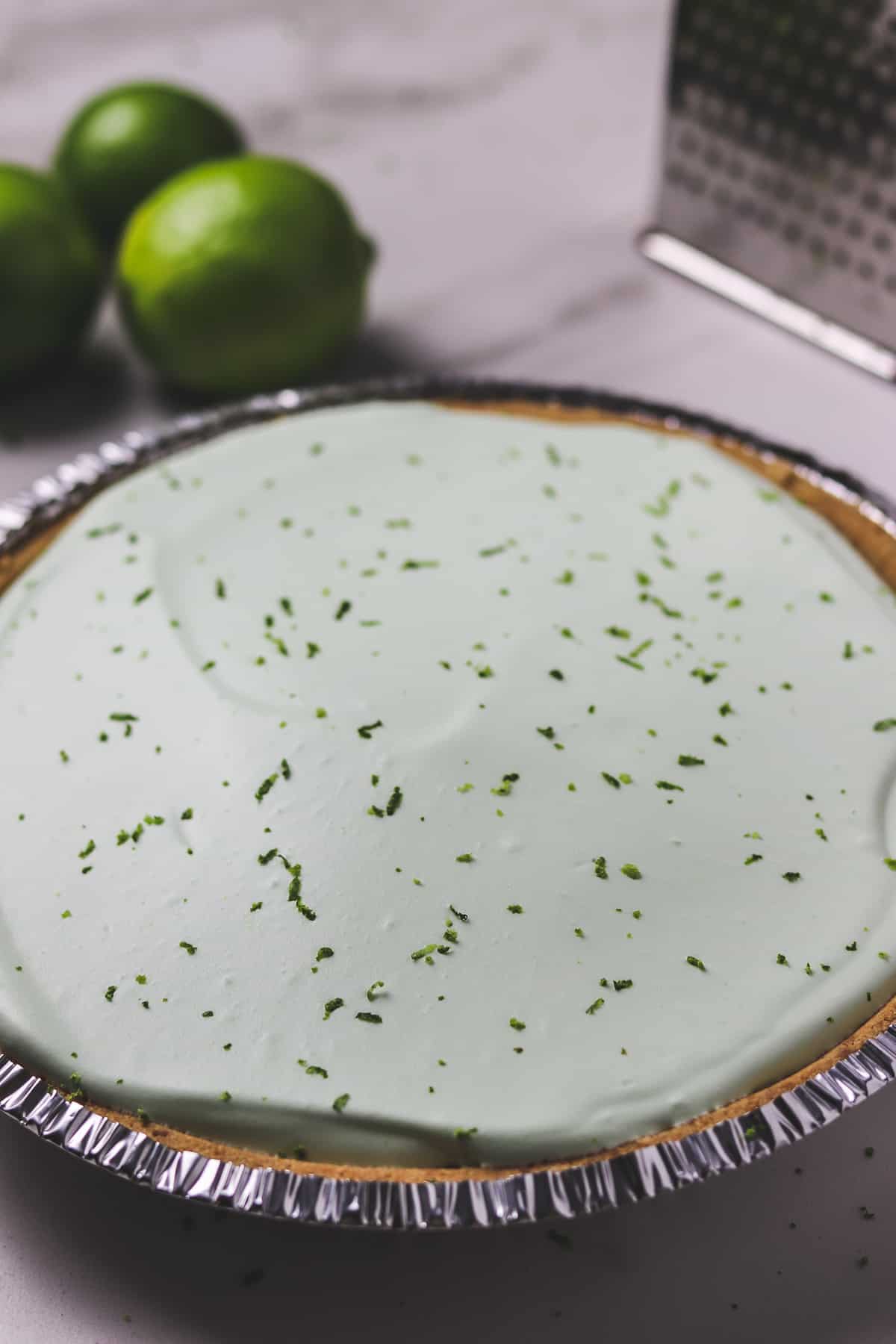 full finished no-bake key lime pie with lime zest garnish on top