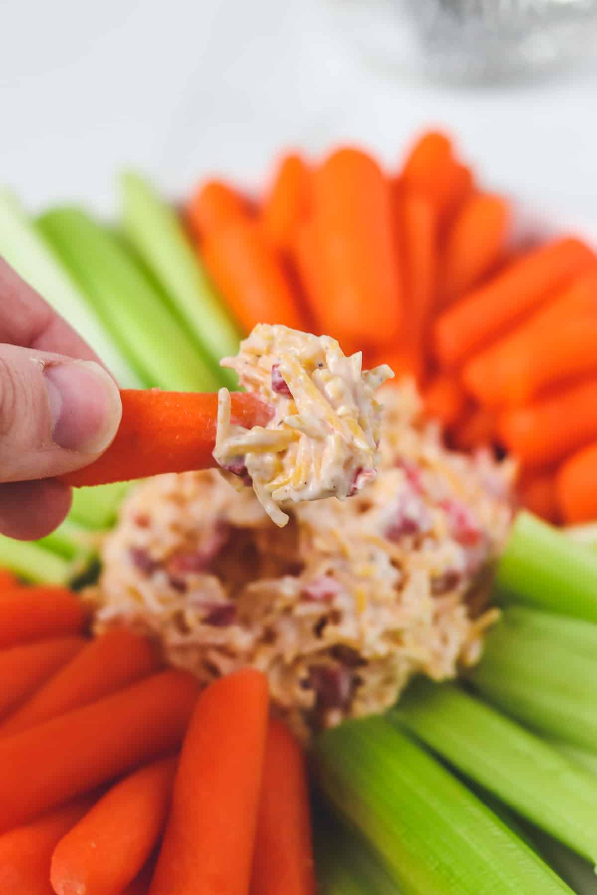 skinny pimento cheese dipped on a carrot