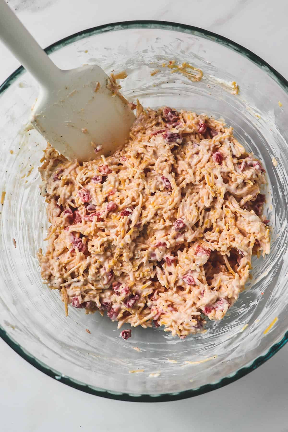 pimento cheese mixed up in clear glass bowl