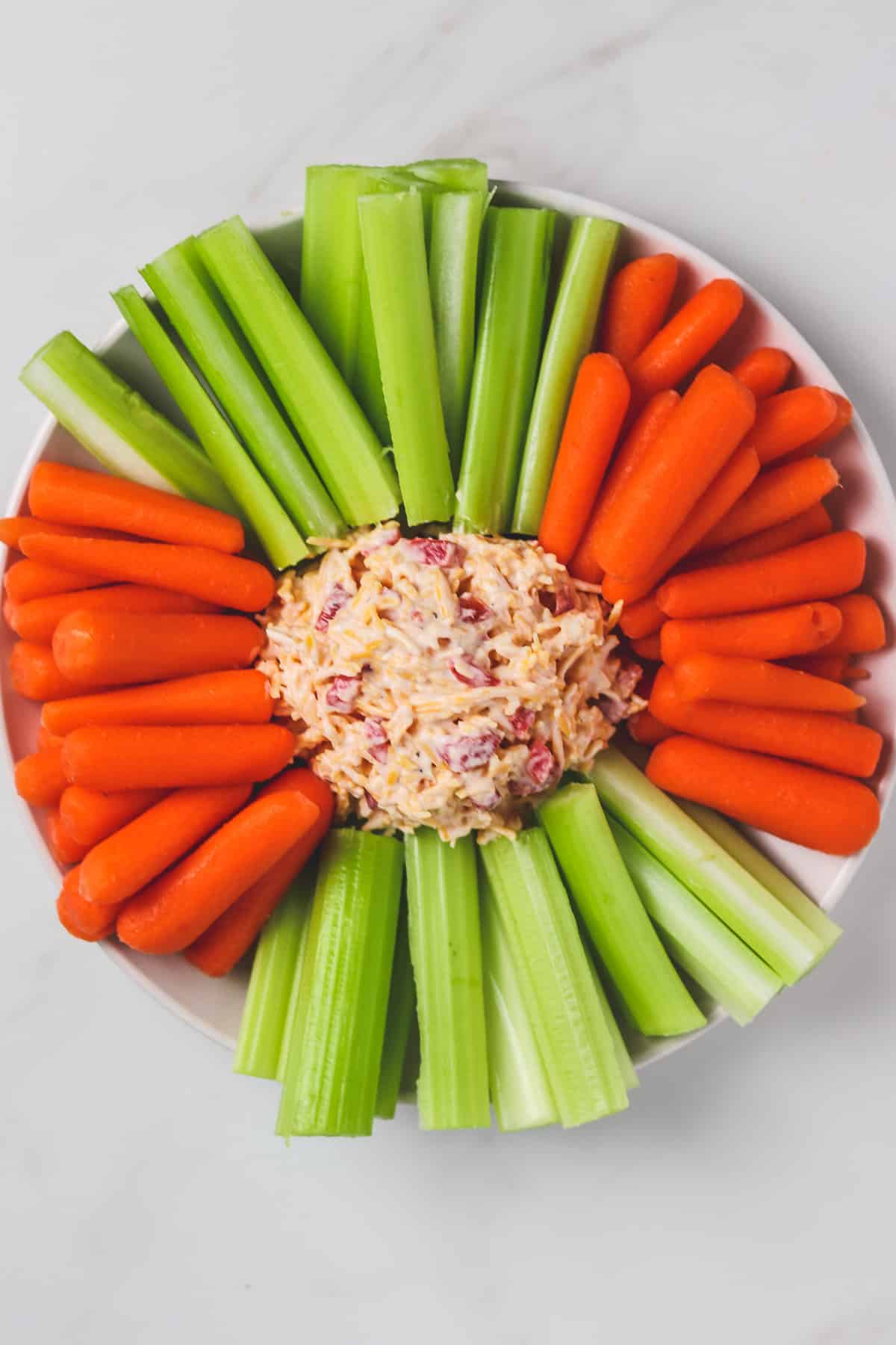 top down view of platter with pimento cheese, carrots, and celery