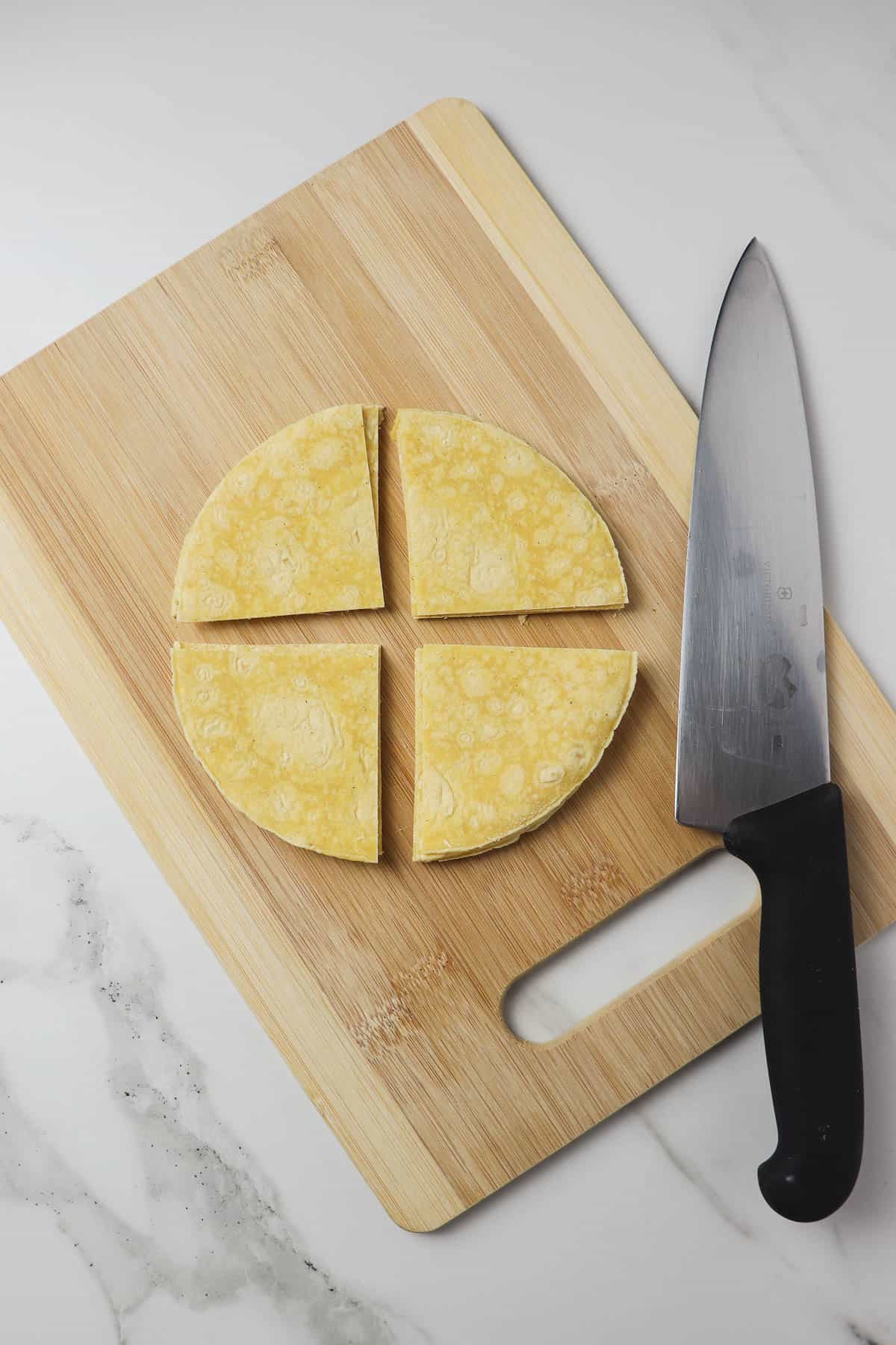 cutting corn tortillas into quarters