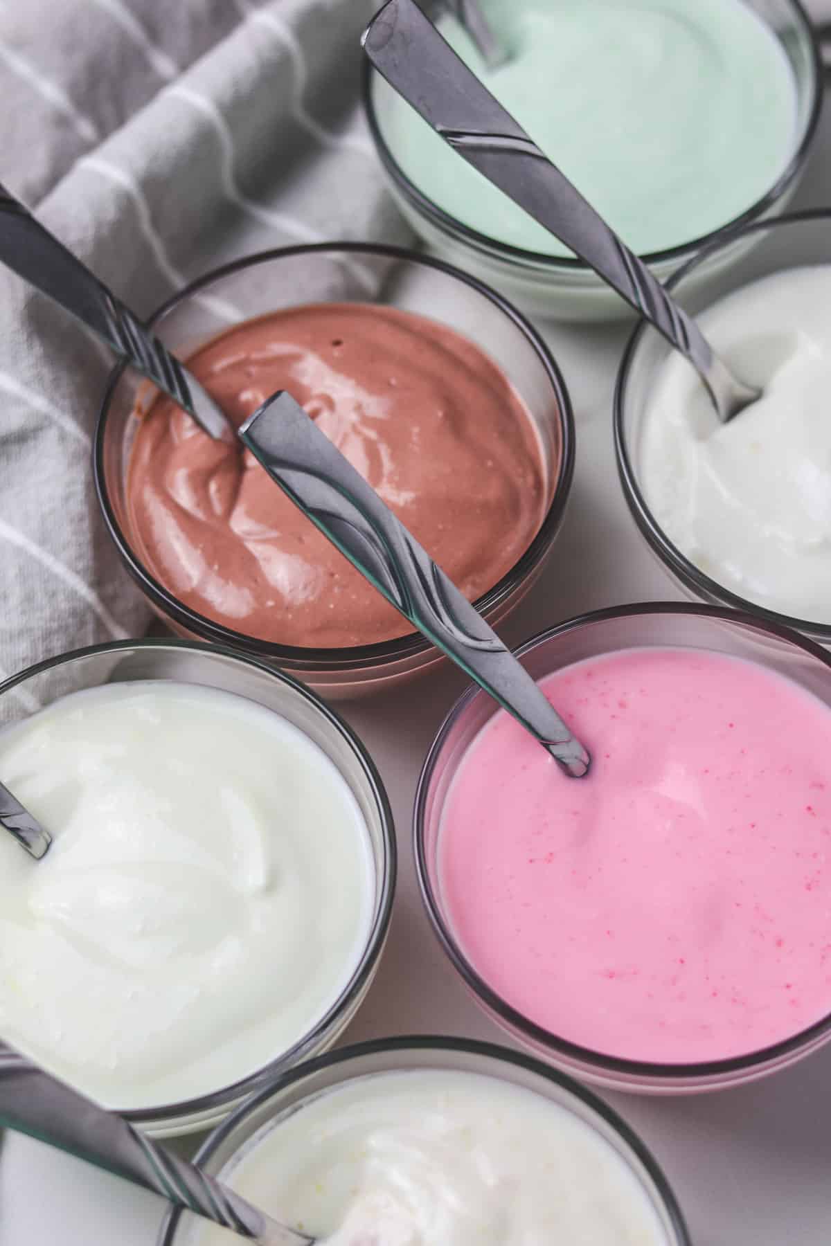 small glass bowls of different flavored yogurt