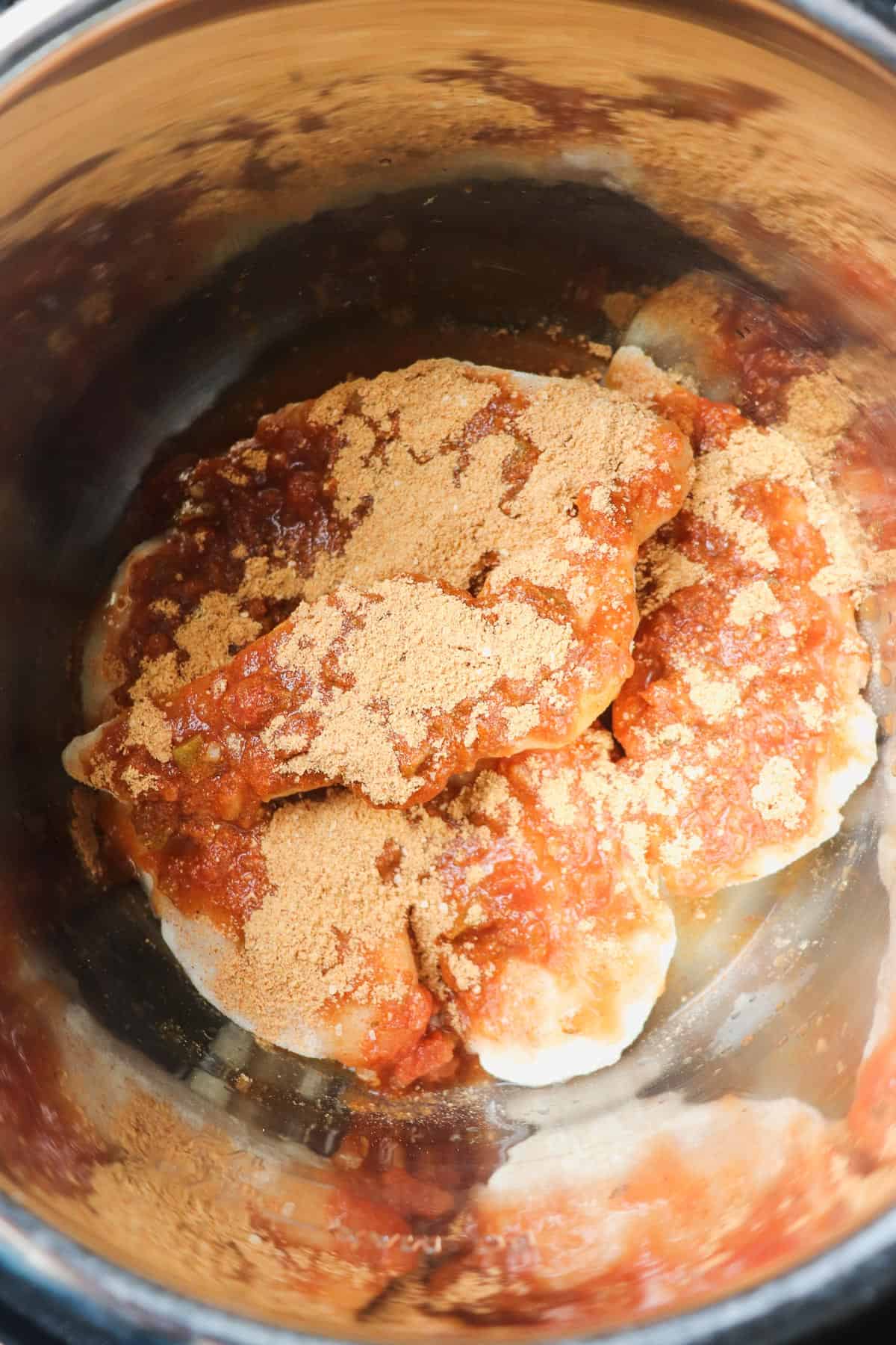 chicken tenders, salsa, and taco seasoning in instant pot liner before cooking