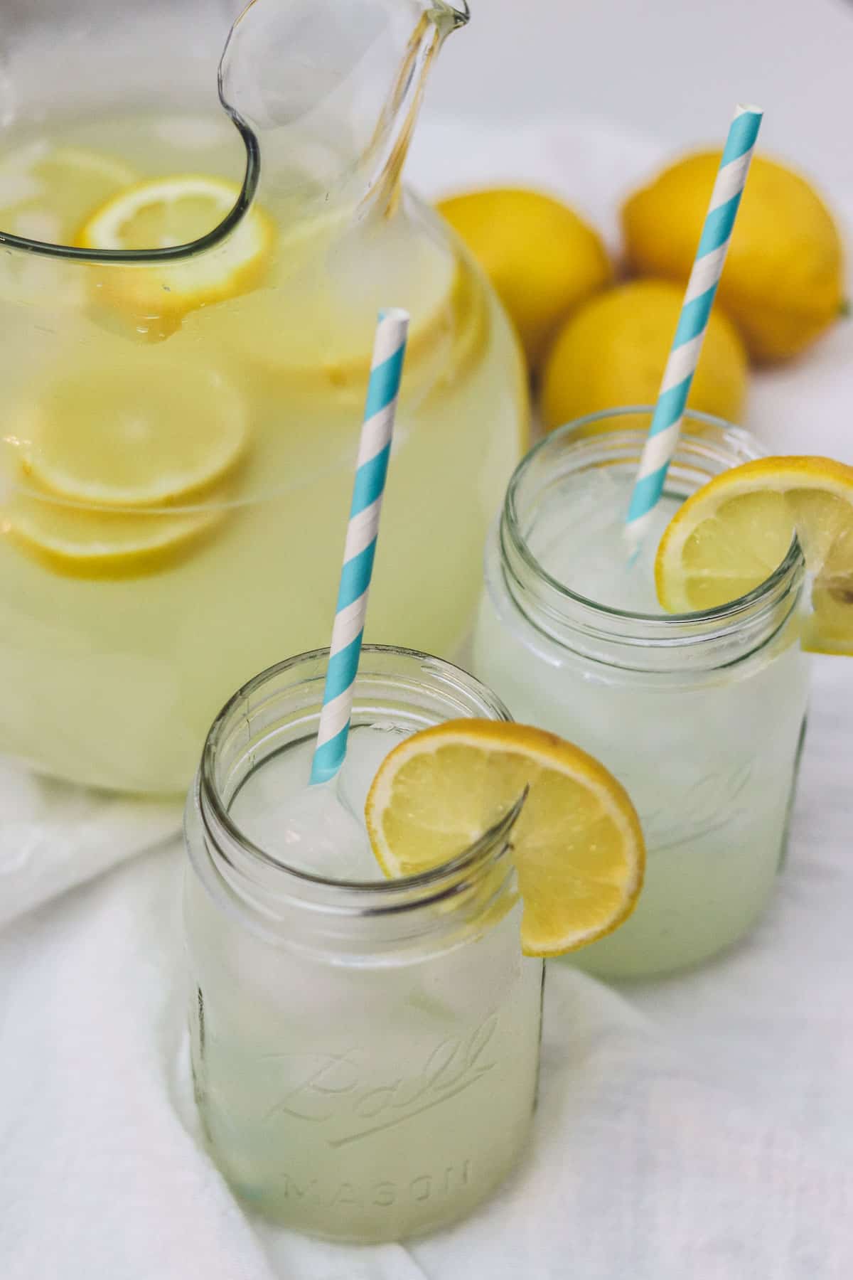 sugar free lemonade in mason jars with pitcher and lemons
