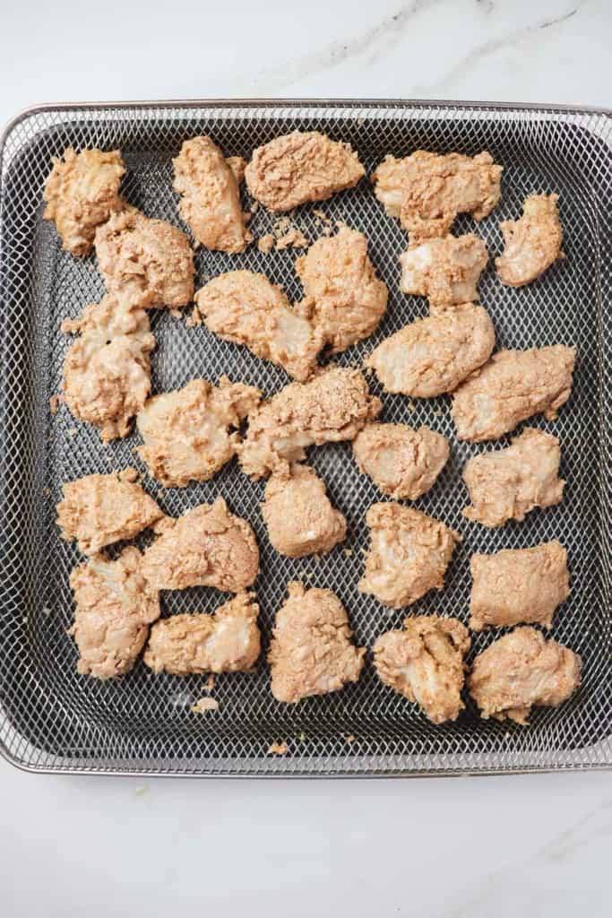 breaded chicken nuggets loaded in air fryer basket