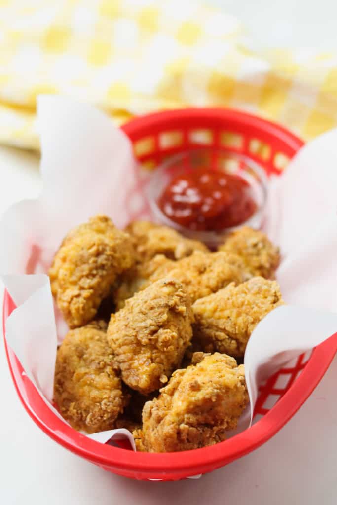 air fryer chicken nuggets in red basket