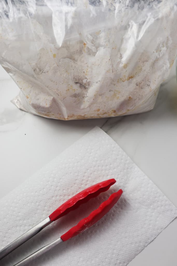 shaking chicken nuggets in gallon bag