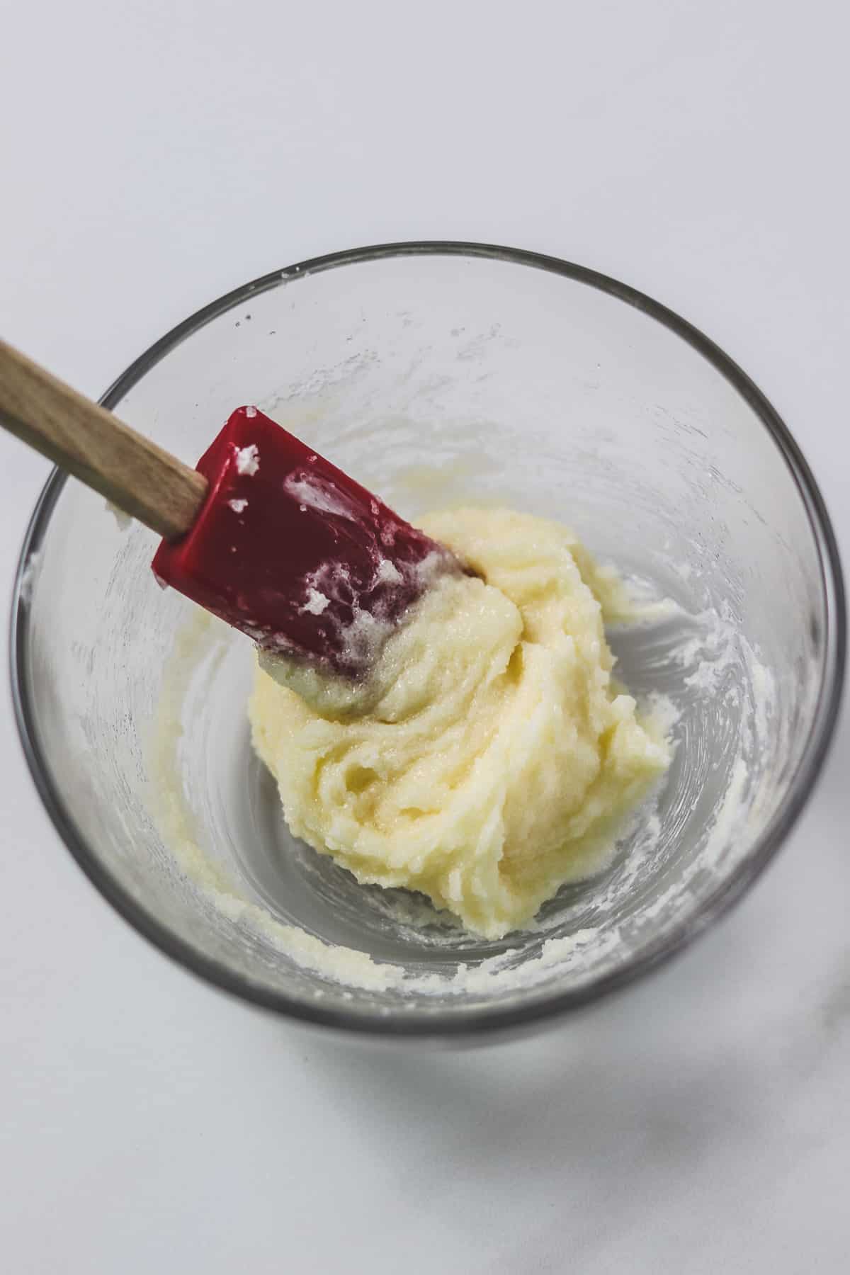 mixing butter and sugar in a small glass bowl