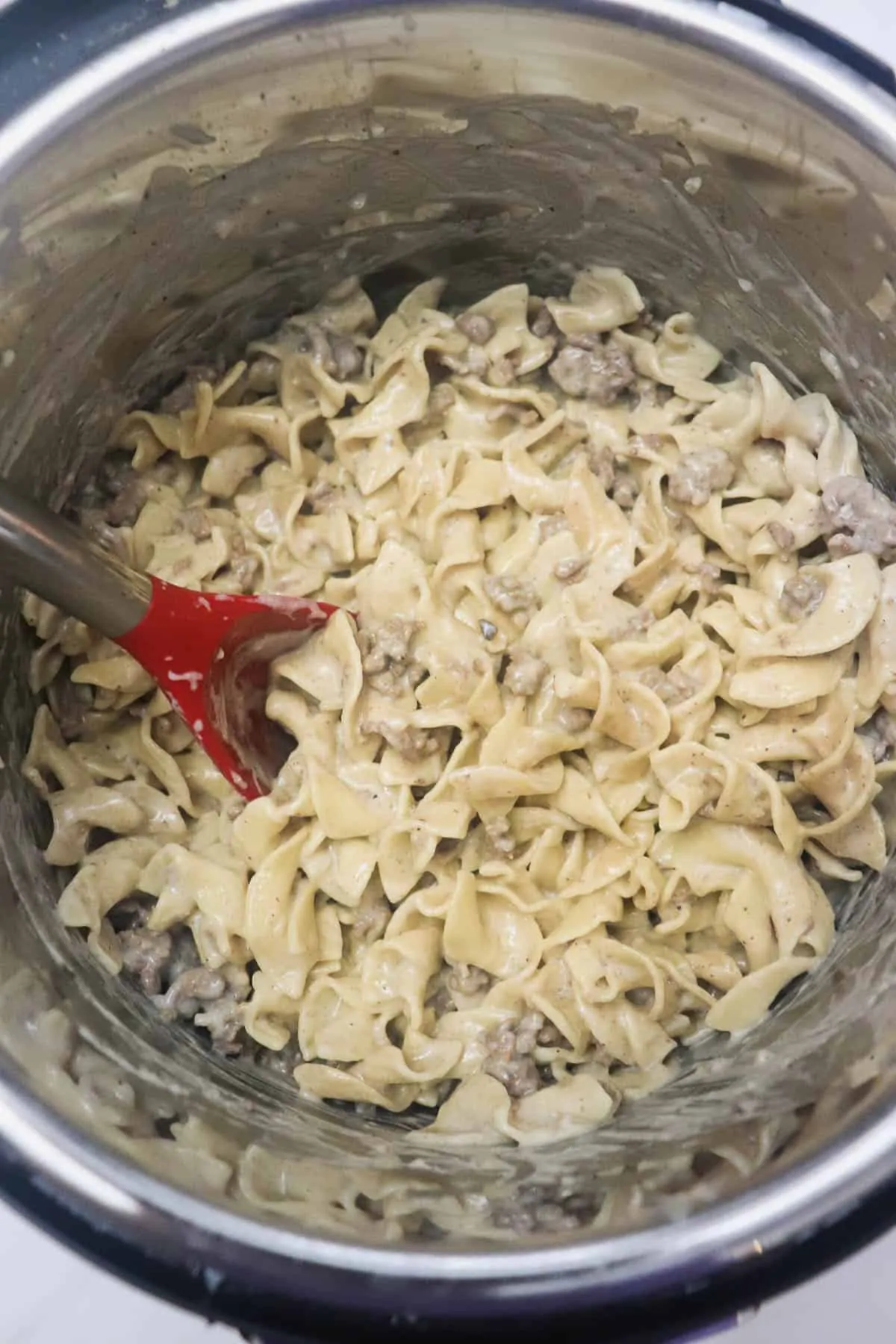 ground beef stroganoff in instant pot with red spoon