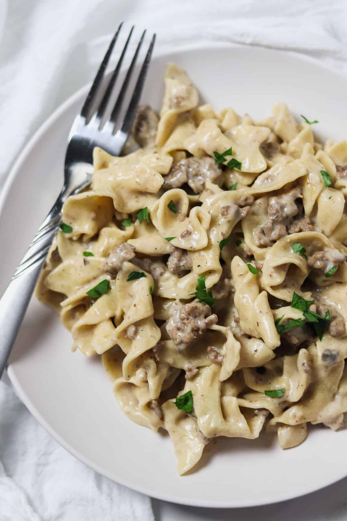 plate of instant pot ground beef stroganoff with fork