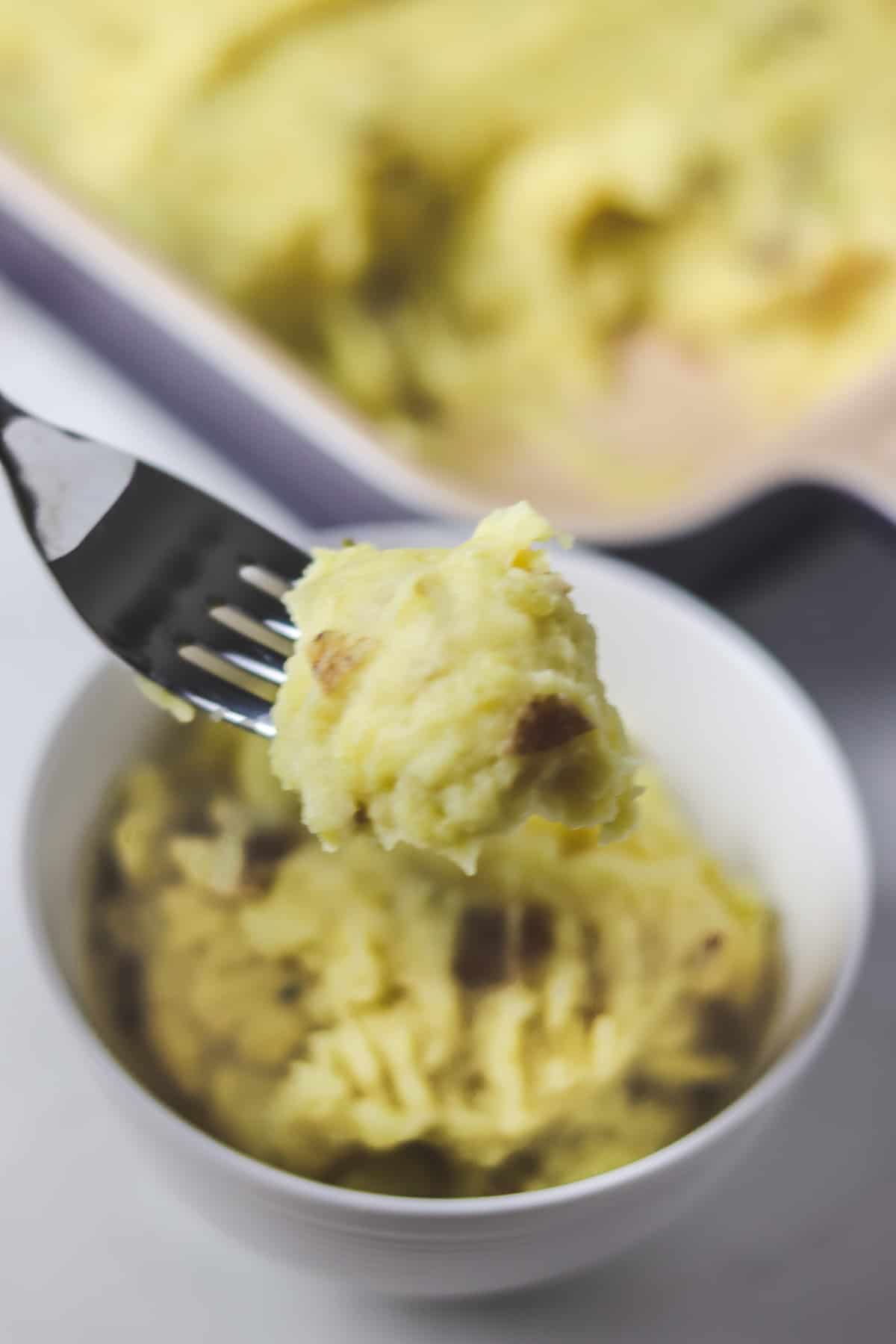 taking a bite out of a bowl of mashed potatoes
