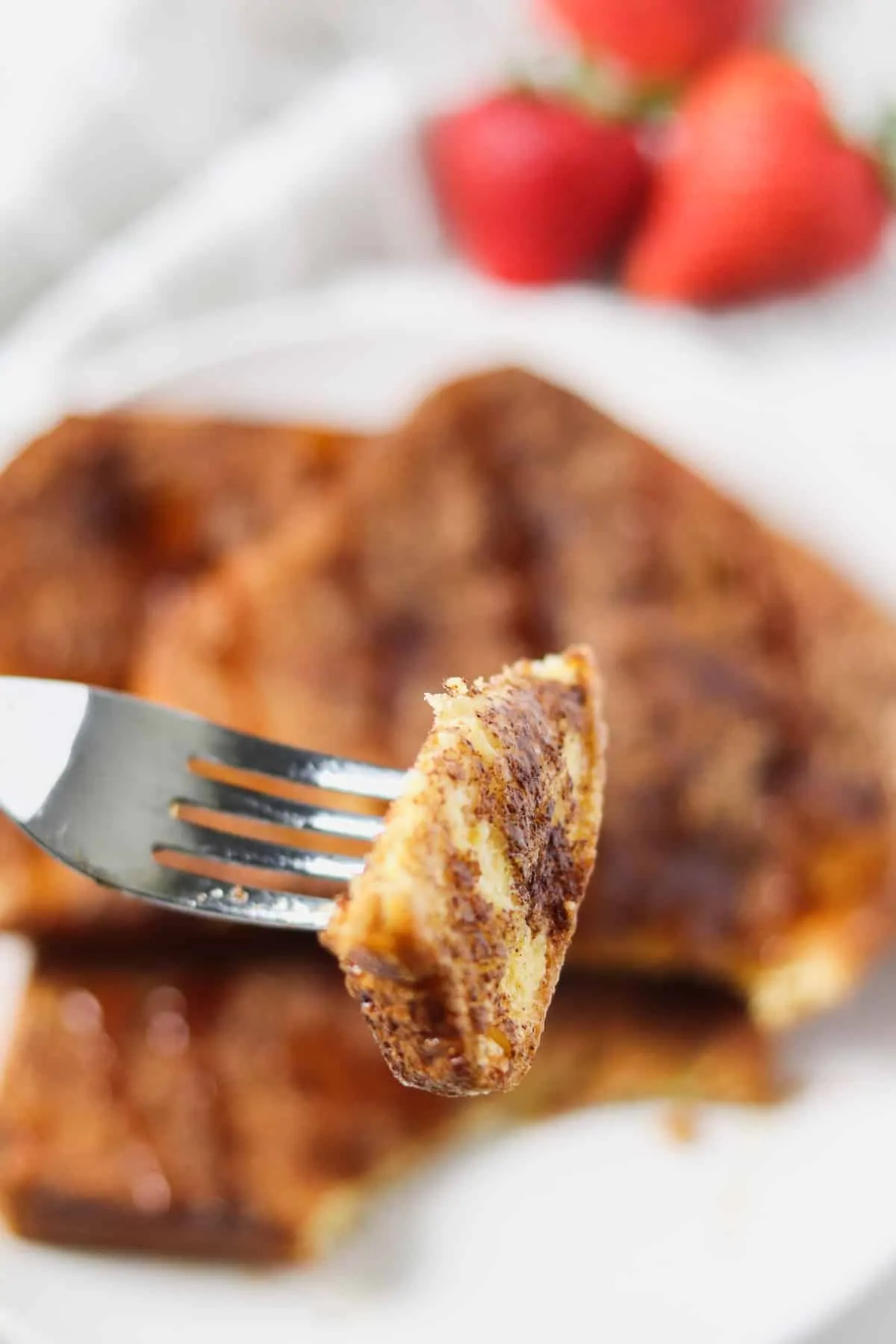 taking a bite of air fryer french toast