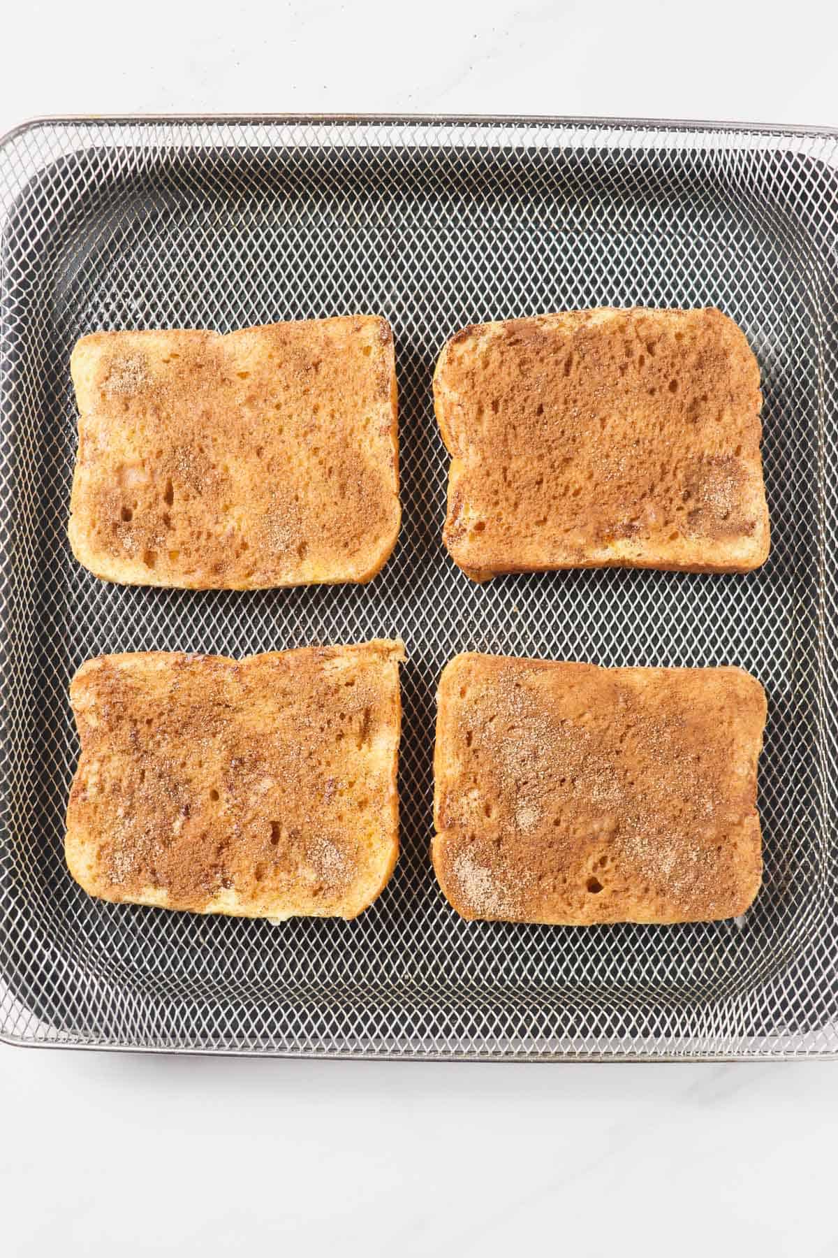 french toast loaded into air fryer basket before baking