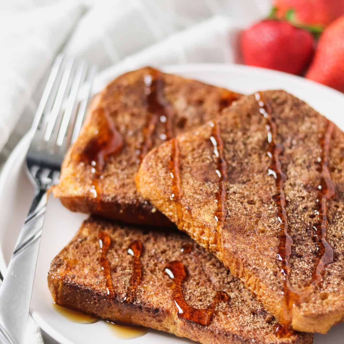 air fryer french toast with syrup drizzled on top