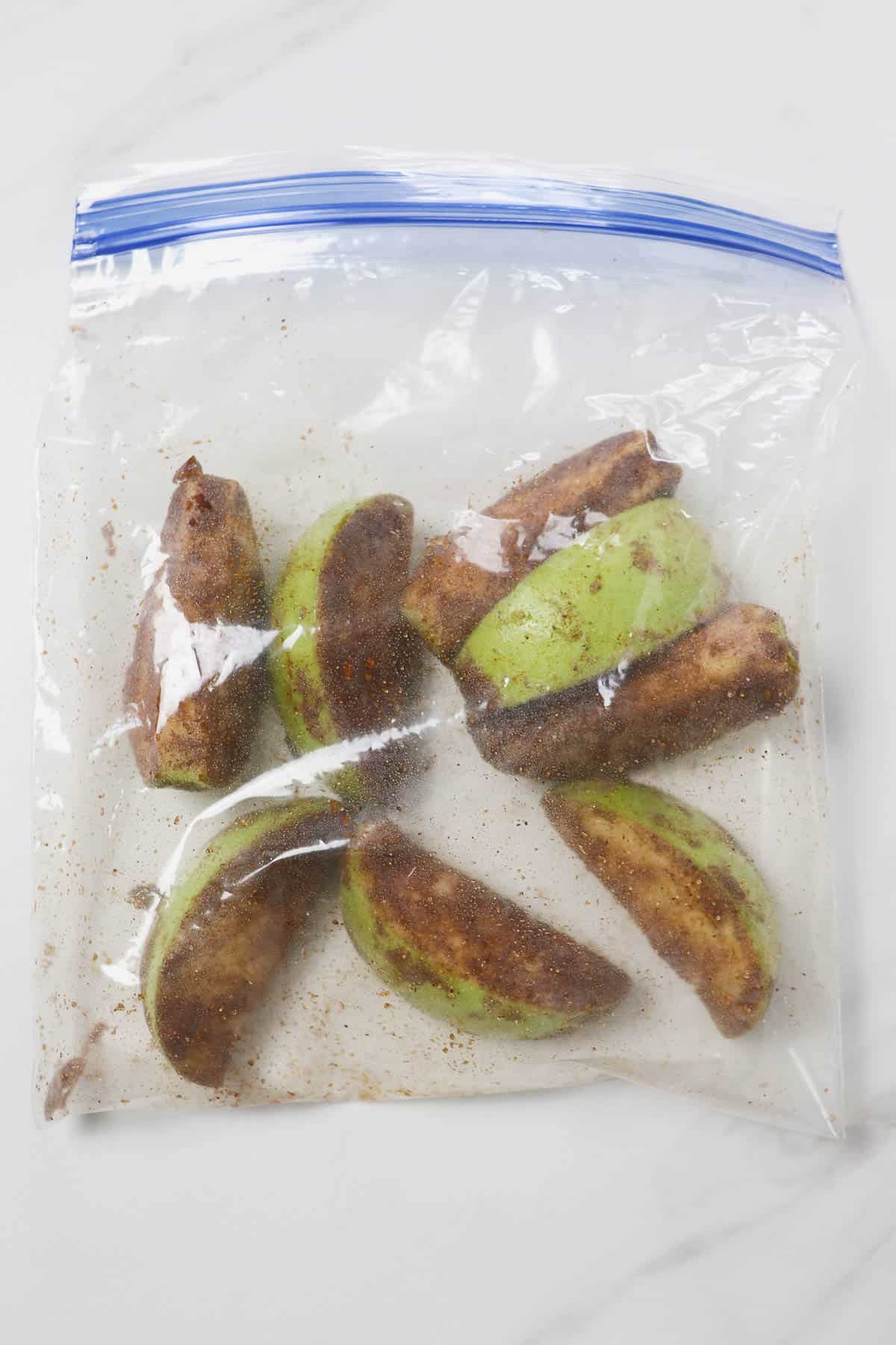 shaking the apple slices in a plastic bag to coat with cinnamon and sugar