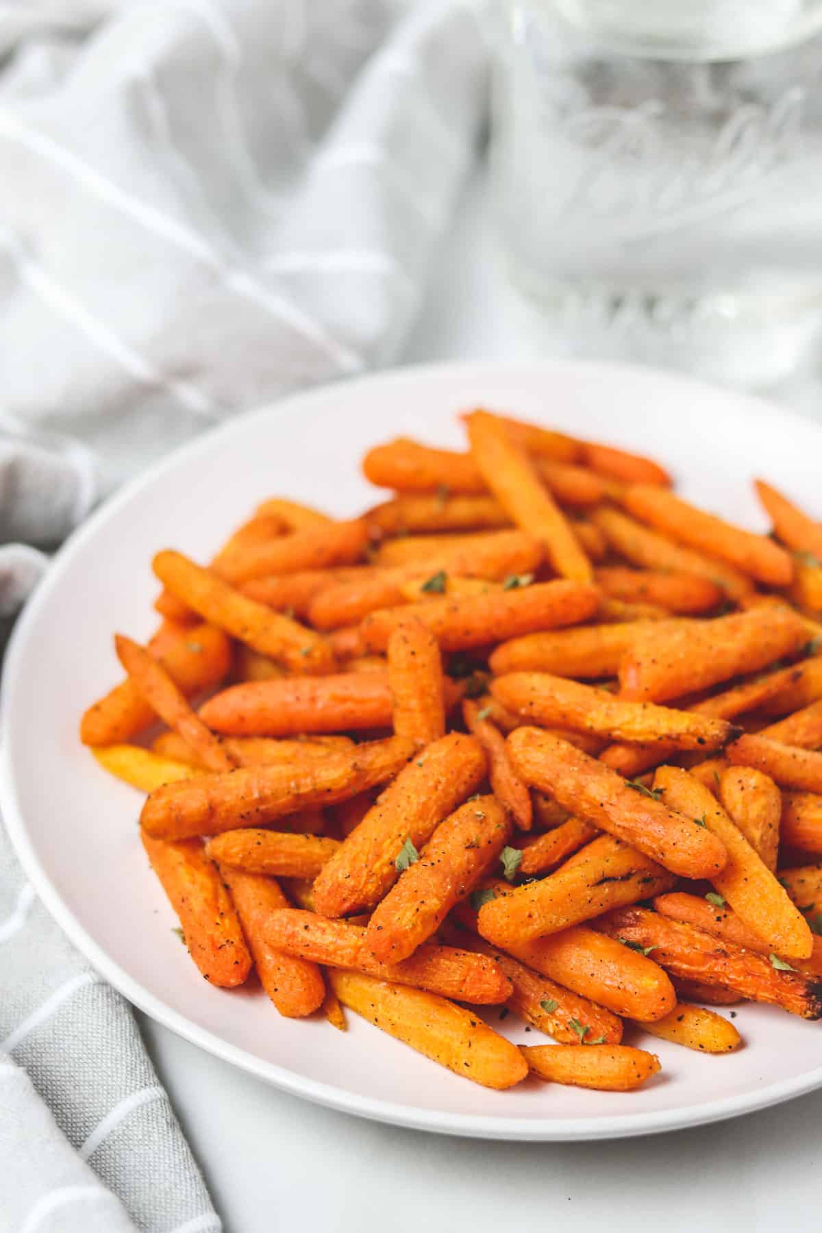 white plate full of air fried baby carrots