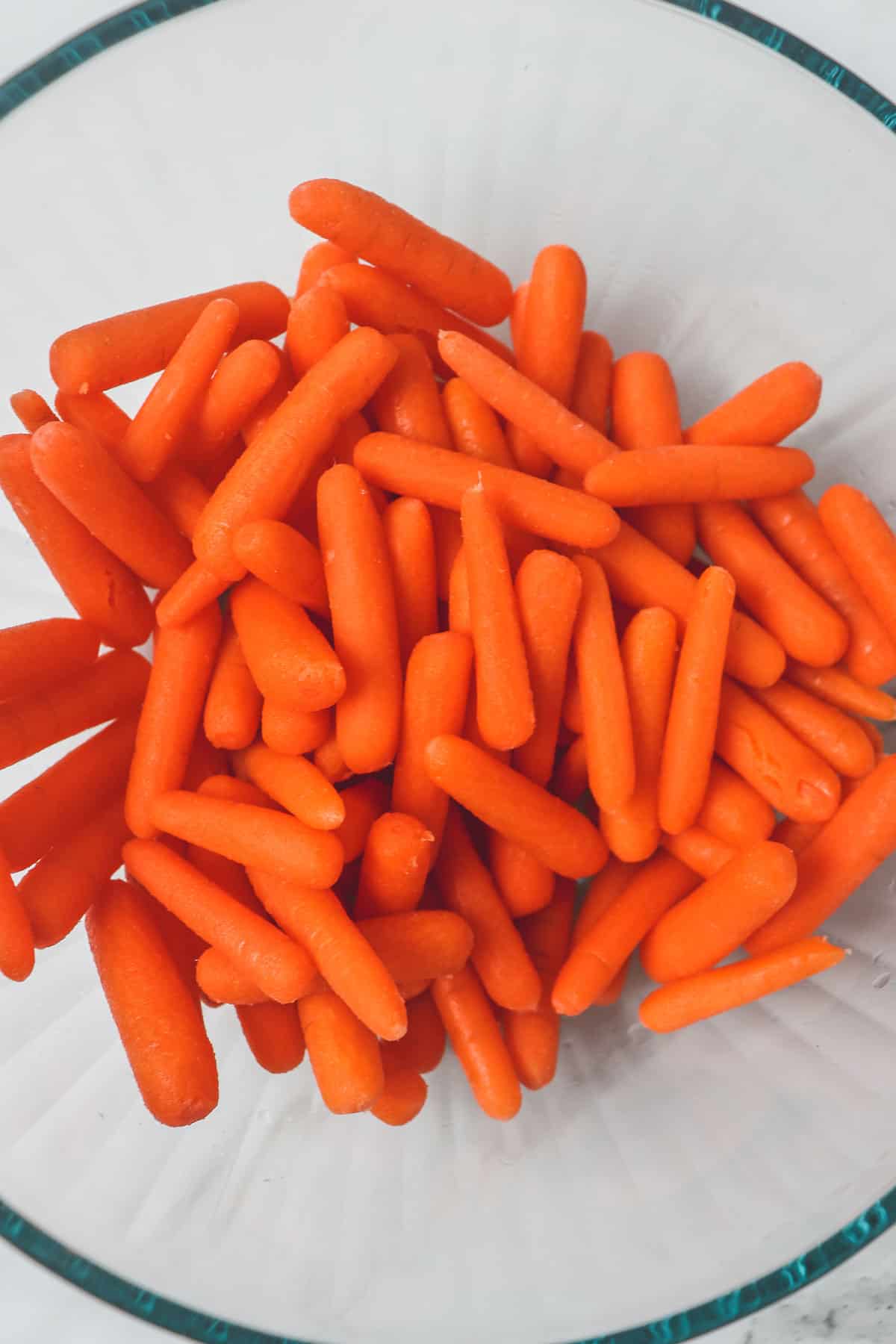 baby carrots in a glass mixing bowl