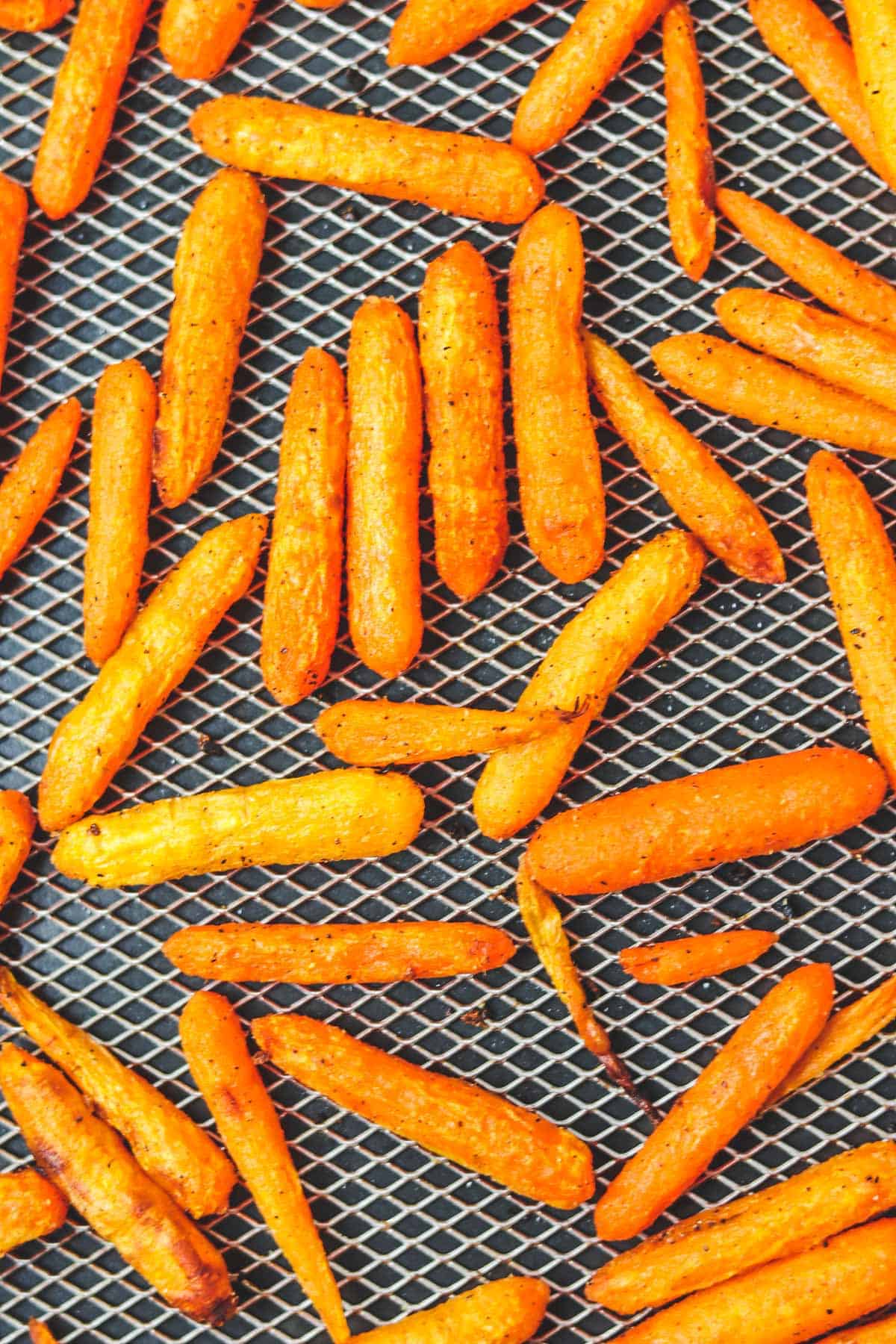finished roasted carrots in air fryer basket zoom in