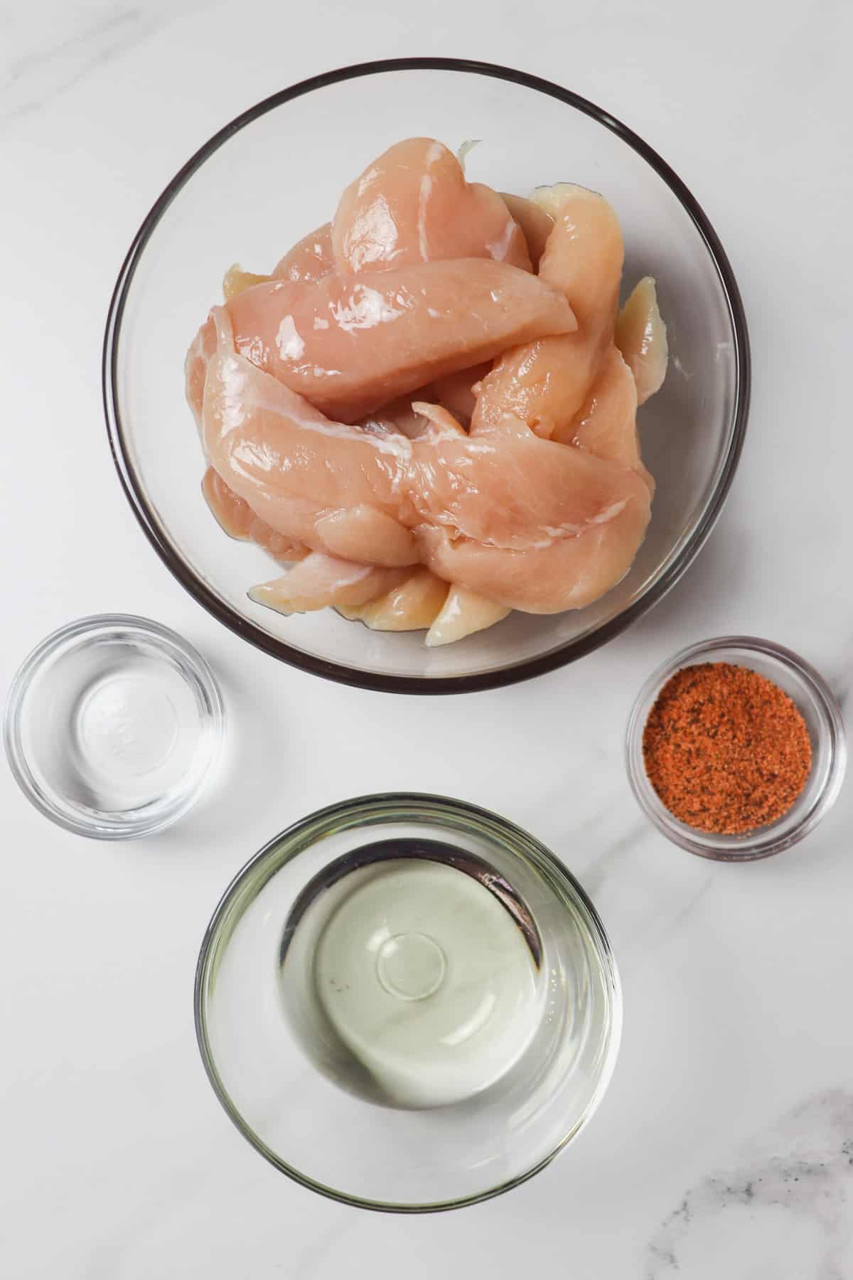 ingredients in air fryer naked chicken tenders in glass bowls