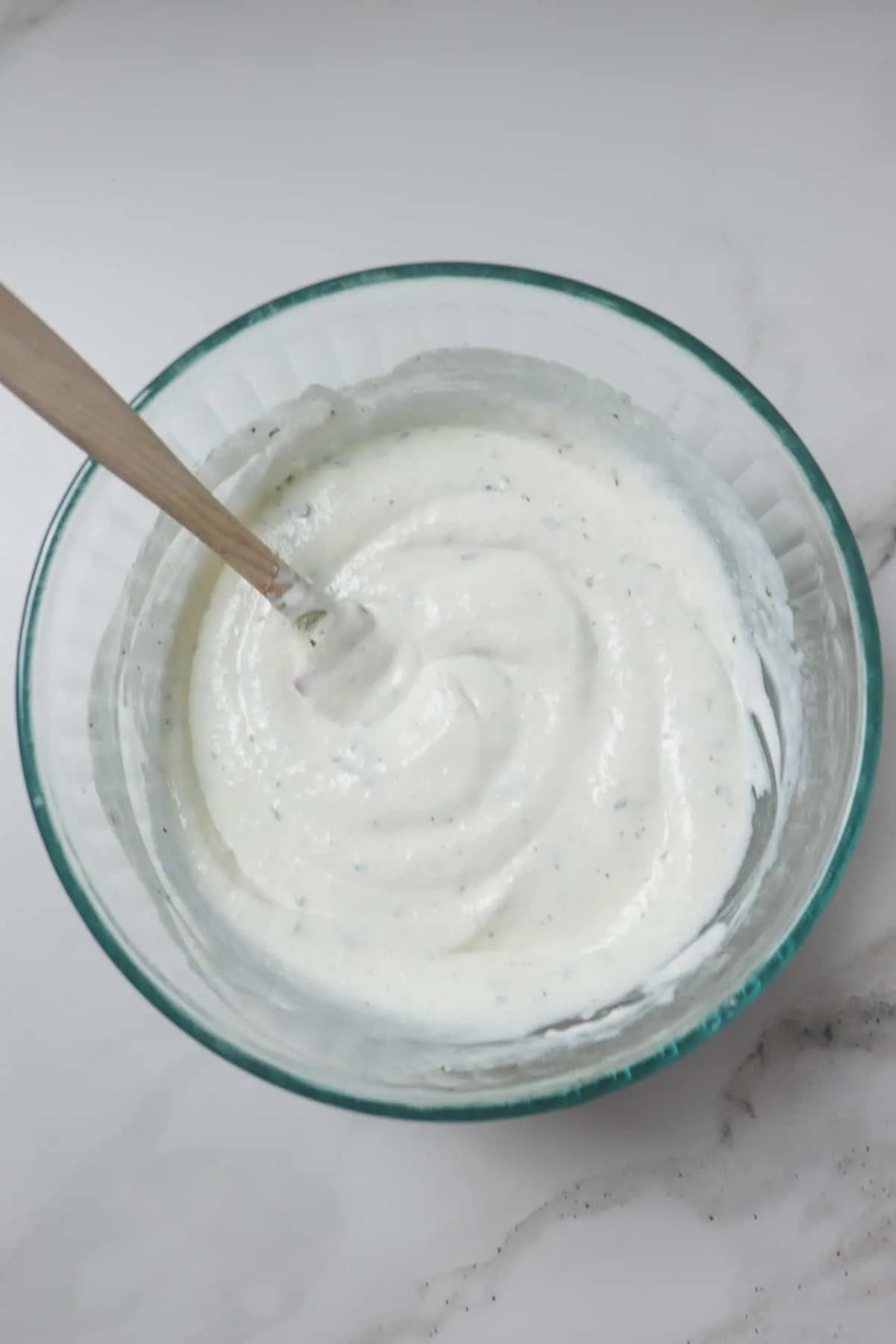 mixing ranch dip in glass bowl