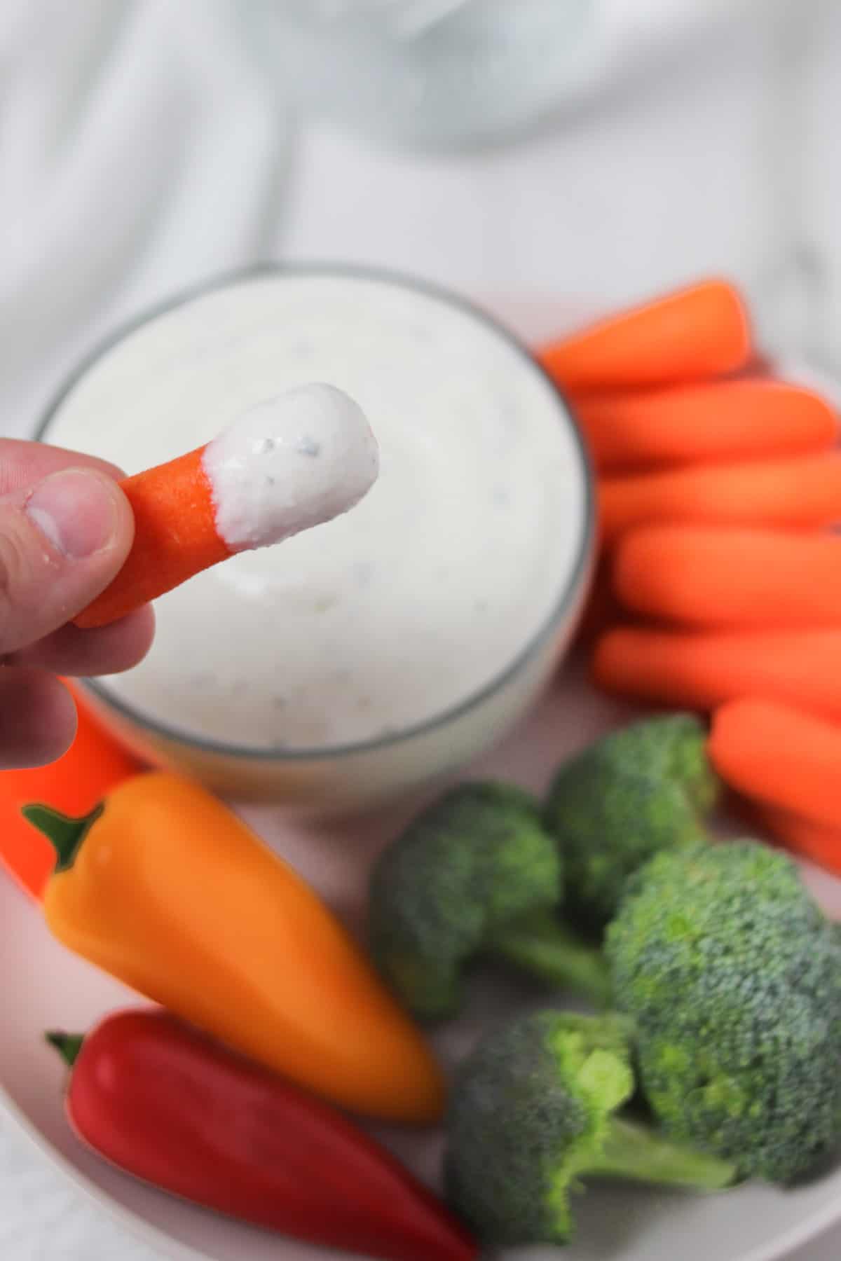 dipping a carrot in ranch dip