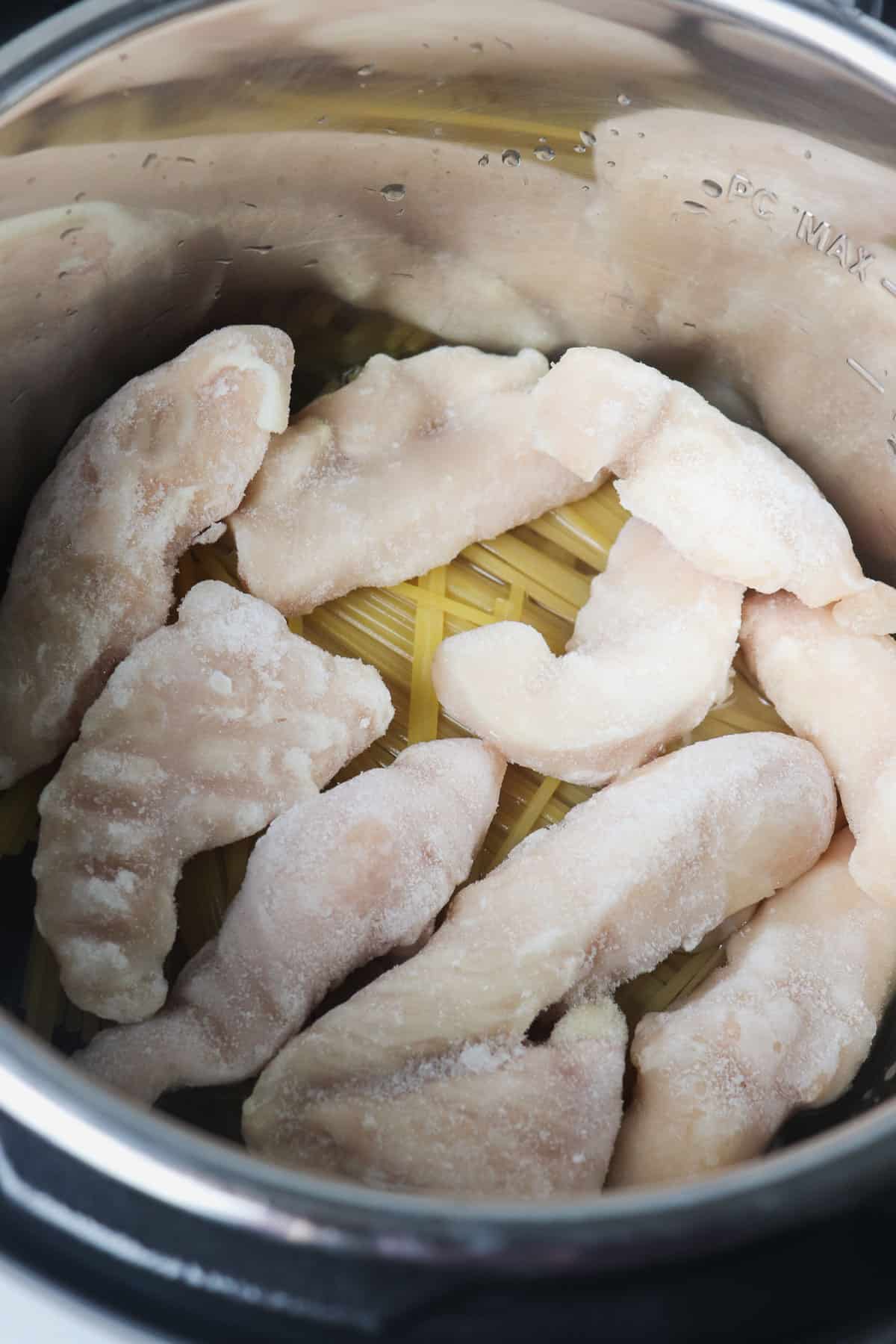 noodles and chicken tenders layered in the instant pot