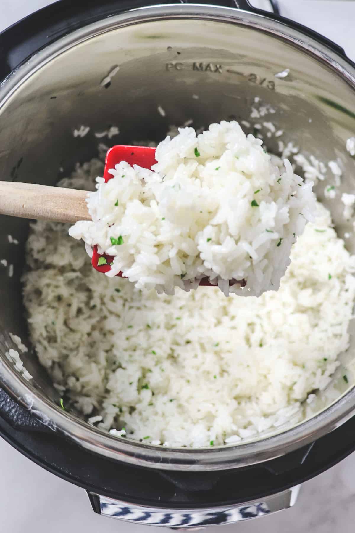 scooping a spoonful of cilantro lime rice out of the instant pot