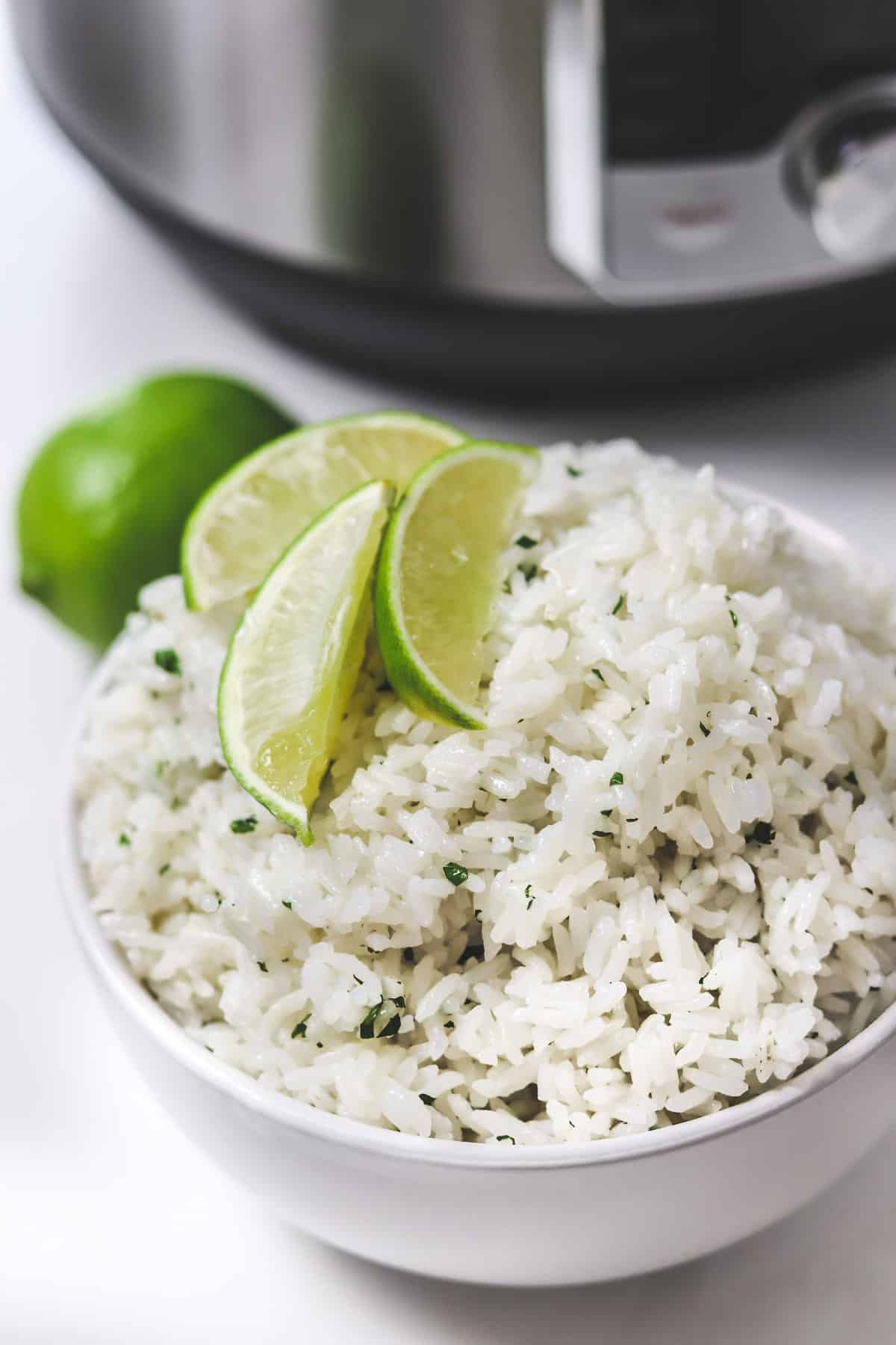 bowl of cilantro lime rice with lime wedges on top