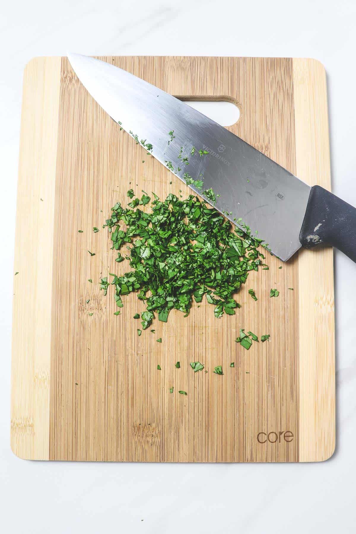 chopping fresh cilantro on a cutting board