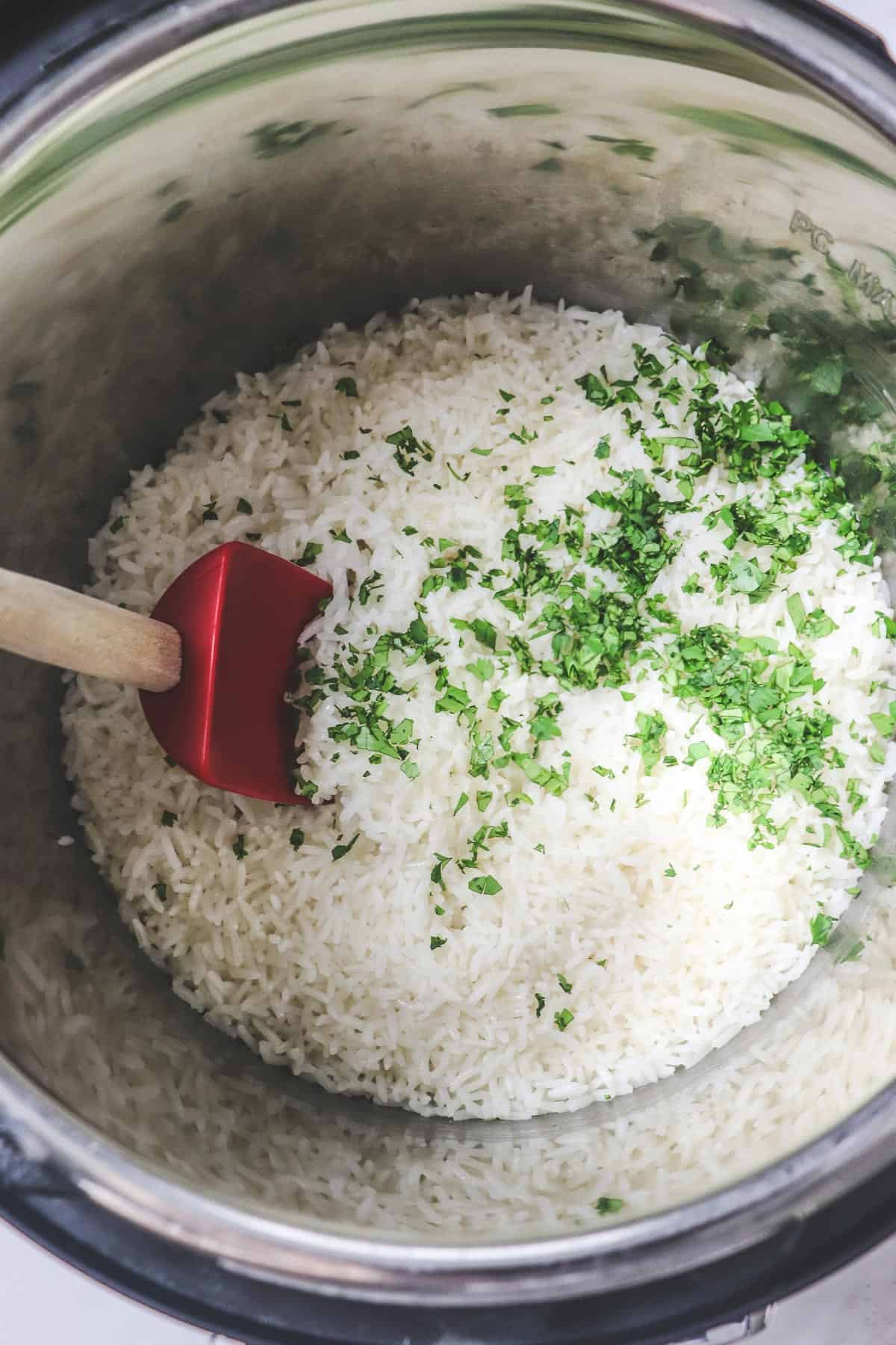 mixing fresh cilantro into the rice in the instant pot