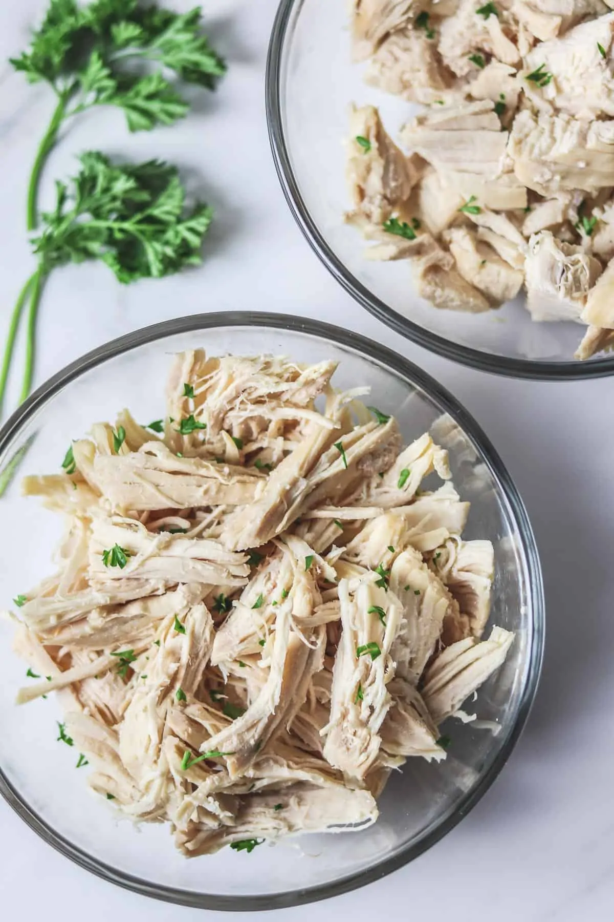 bowls of shredded and diced chicken breast and tenderloin