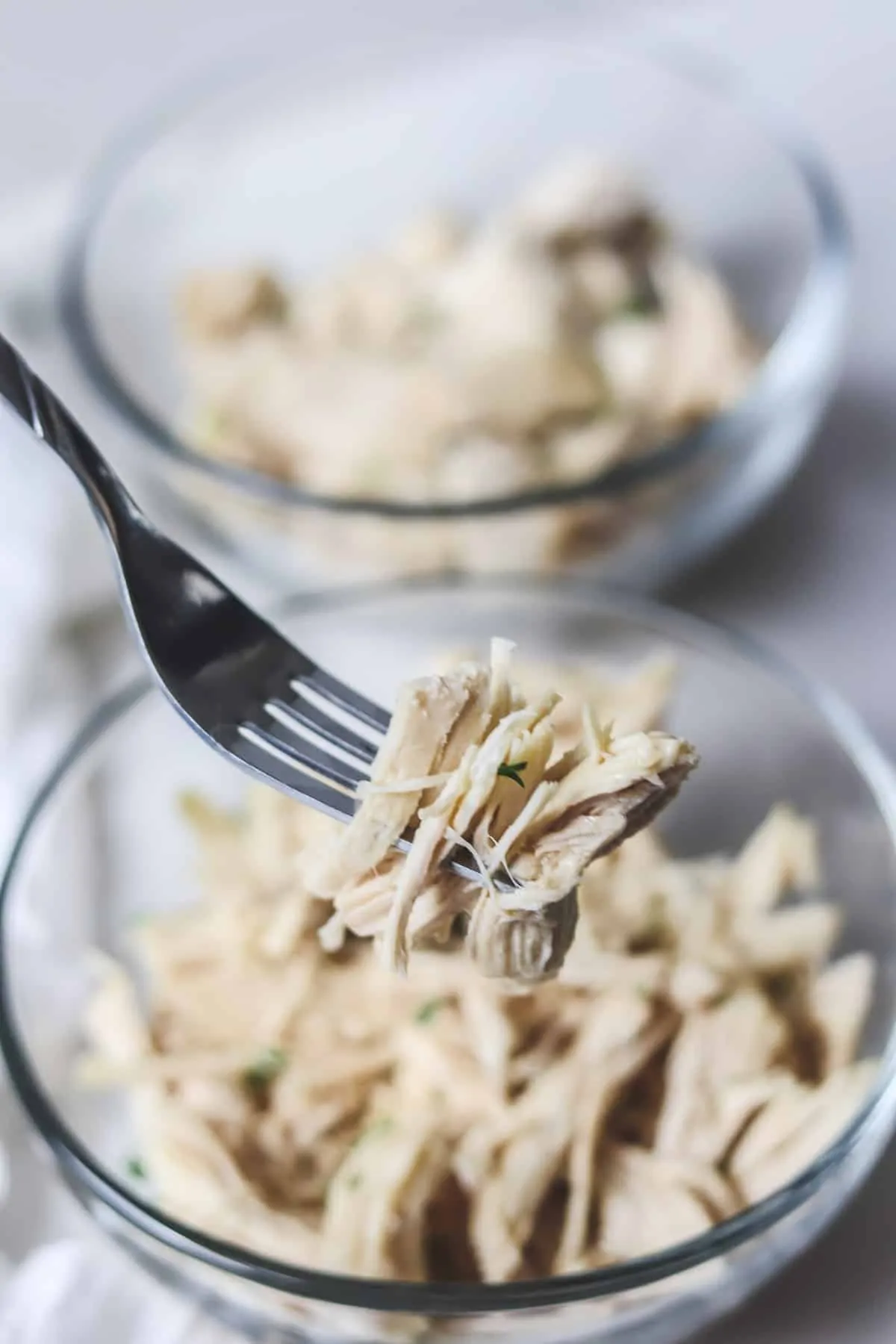 taking a bite of shredded chicken breast